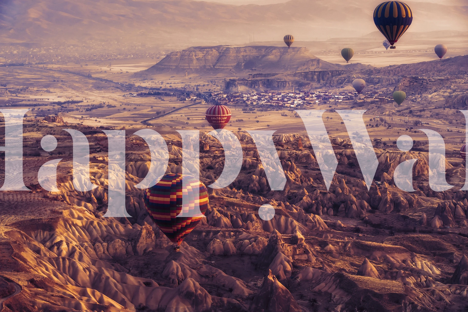 Colorful hot air balloons above a rocky landscape wallpaper
