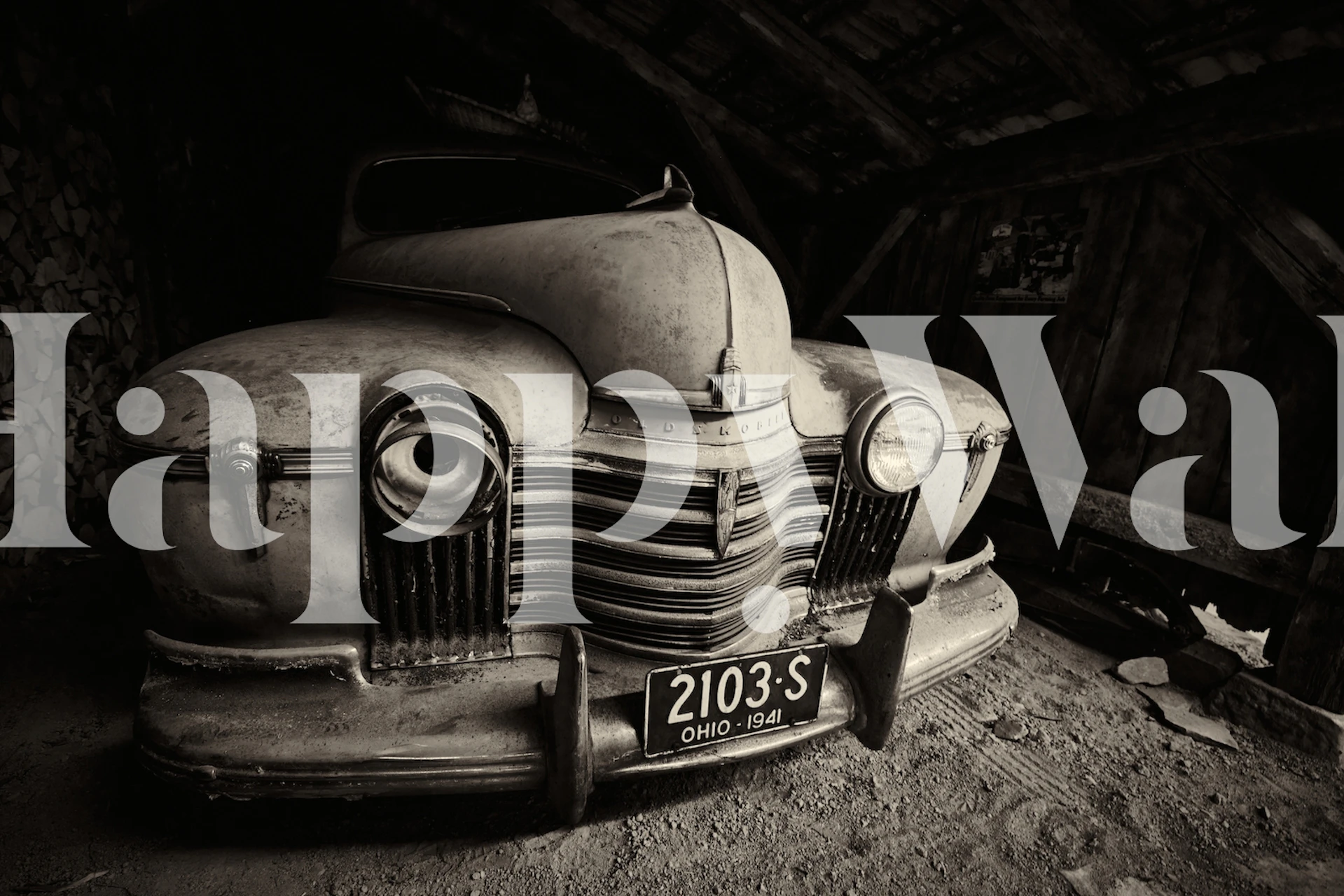 Oldsmobile car parked in a barn, sepia tones, vintage wallpaper