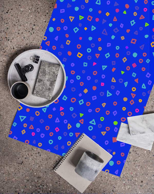 Confetti pattern on neon blue tapet roll