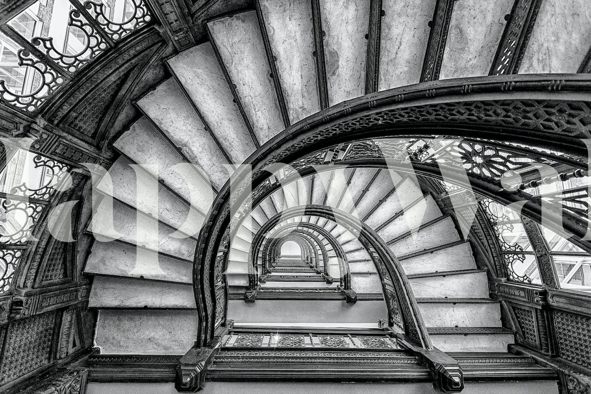 Black and white spiral staircase wallpaper with intricate patterns