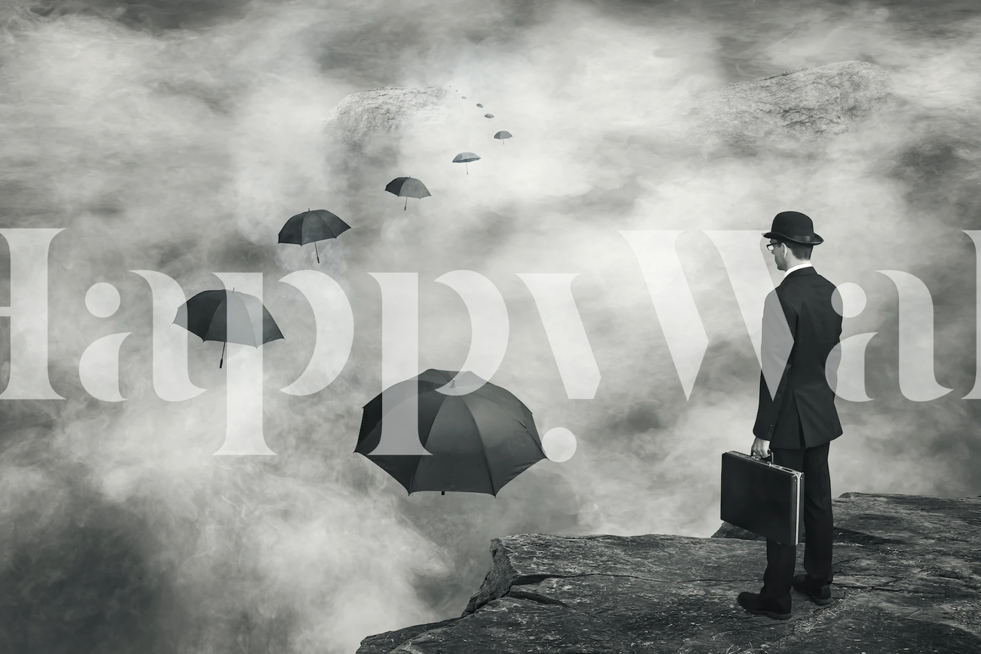 A man in a suit stands on a cliff among floating black umbrellas. Black and white wallpaper.