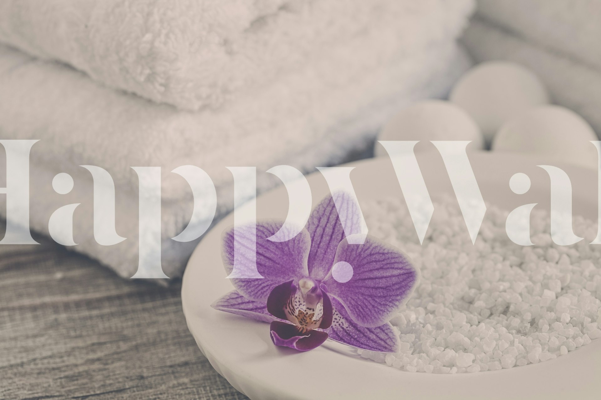 Wall mural with a purple orchid on white sand, fluffy towels in background