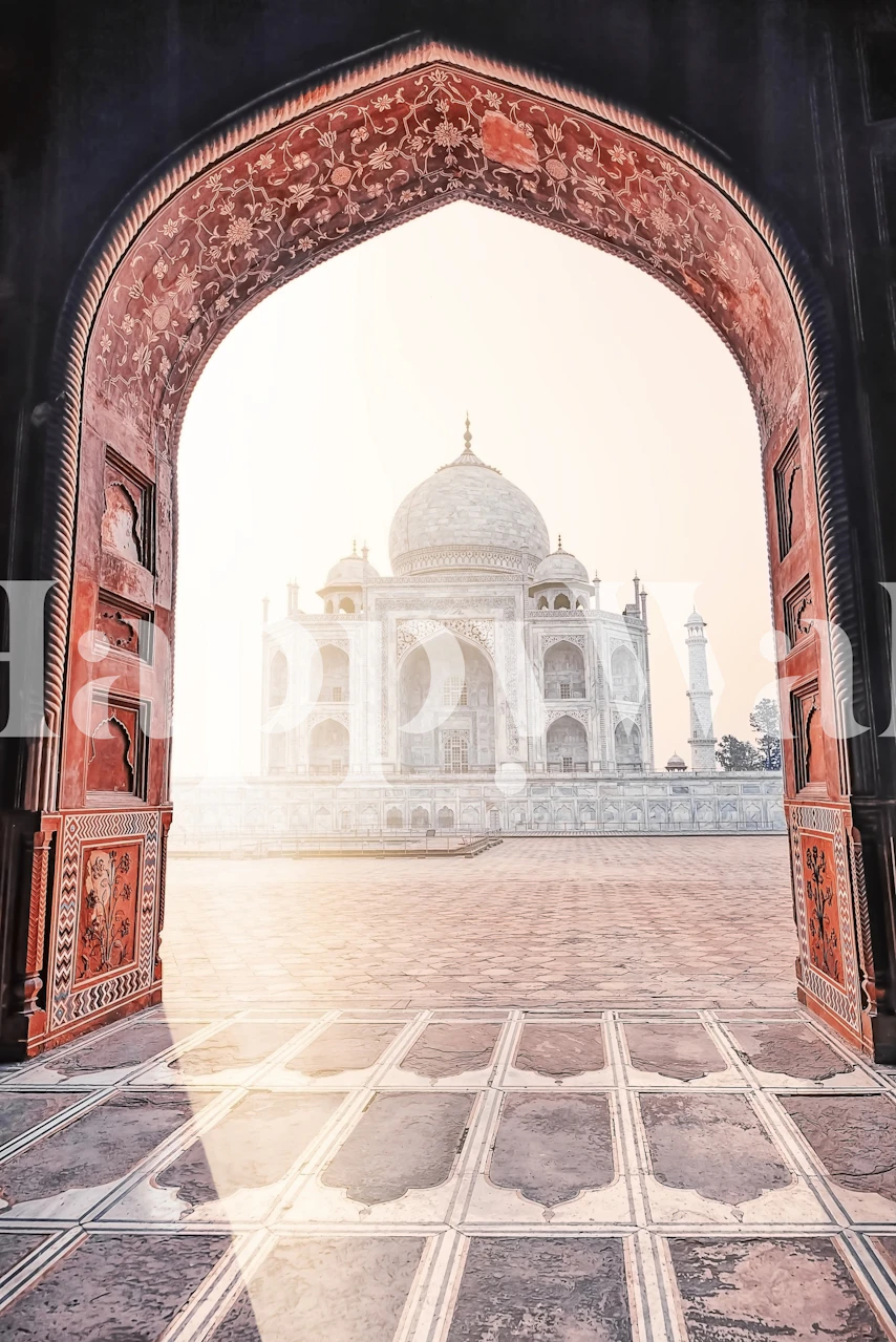 Photo murale du lever du soleil sur le Taj Mahal à travers une arcade