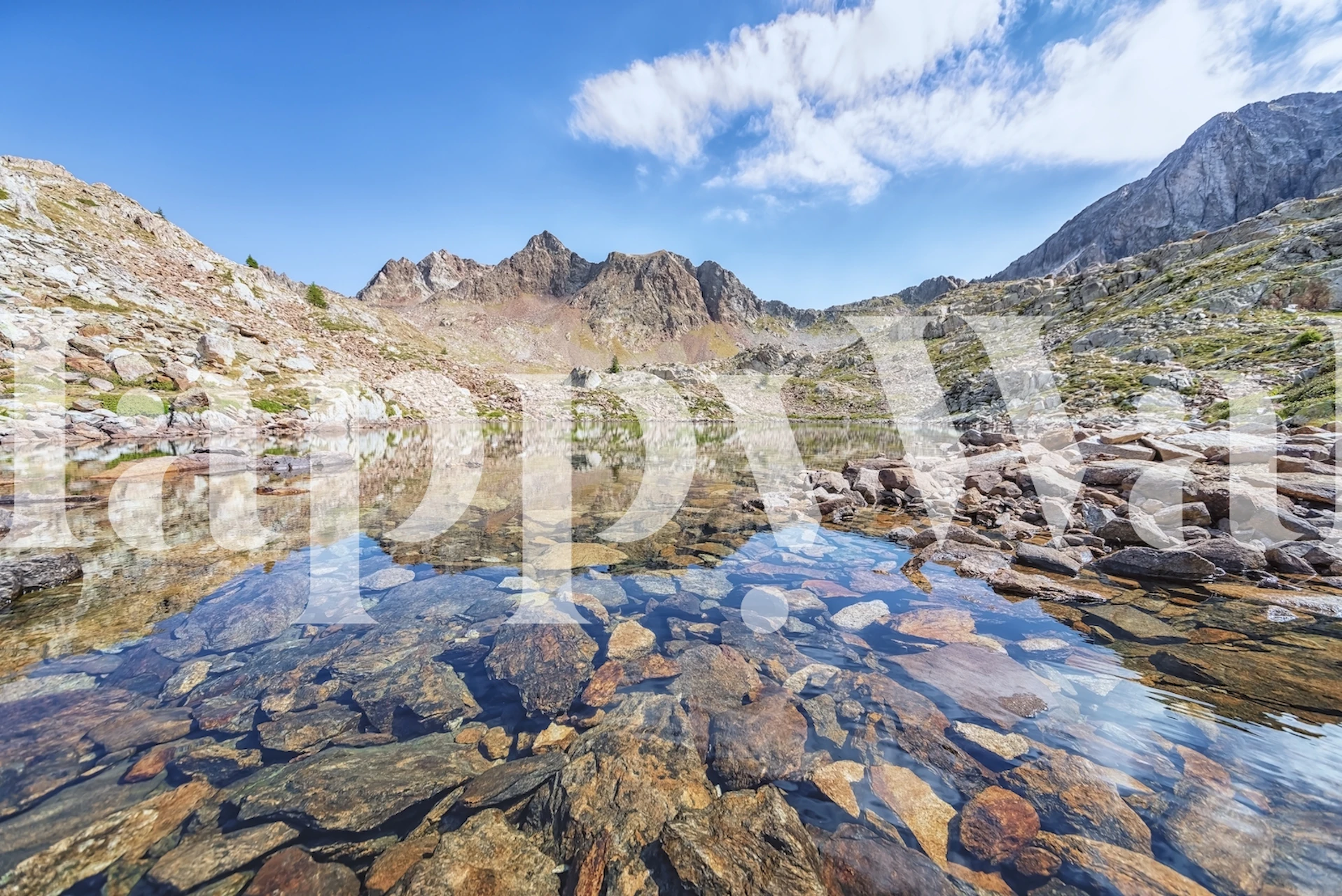 Mountain landscape with rocky terrain and clear water wallpaper