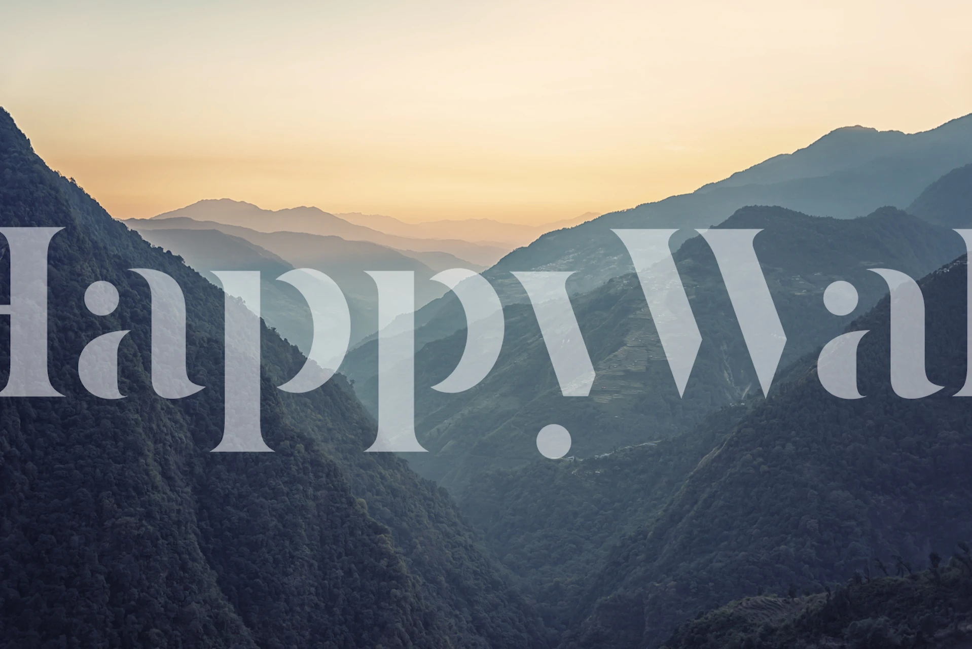 Mountain range at sunset with soft hues of blue and orange wallpaper