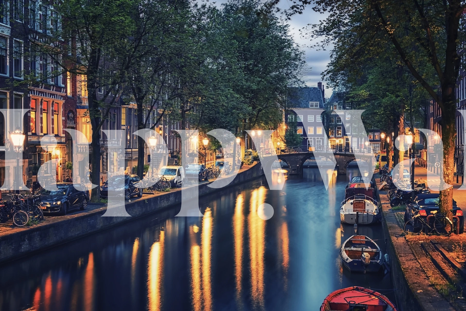 Amsterdam canal at night with warm tones and urban scenery wallpaper