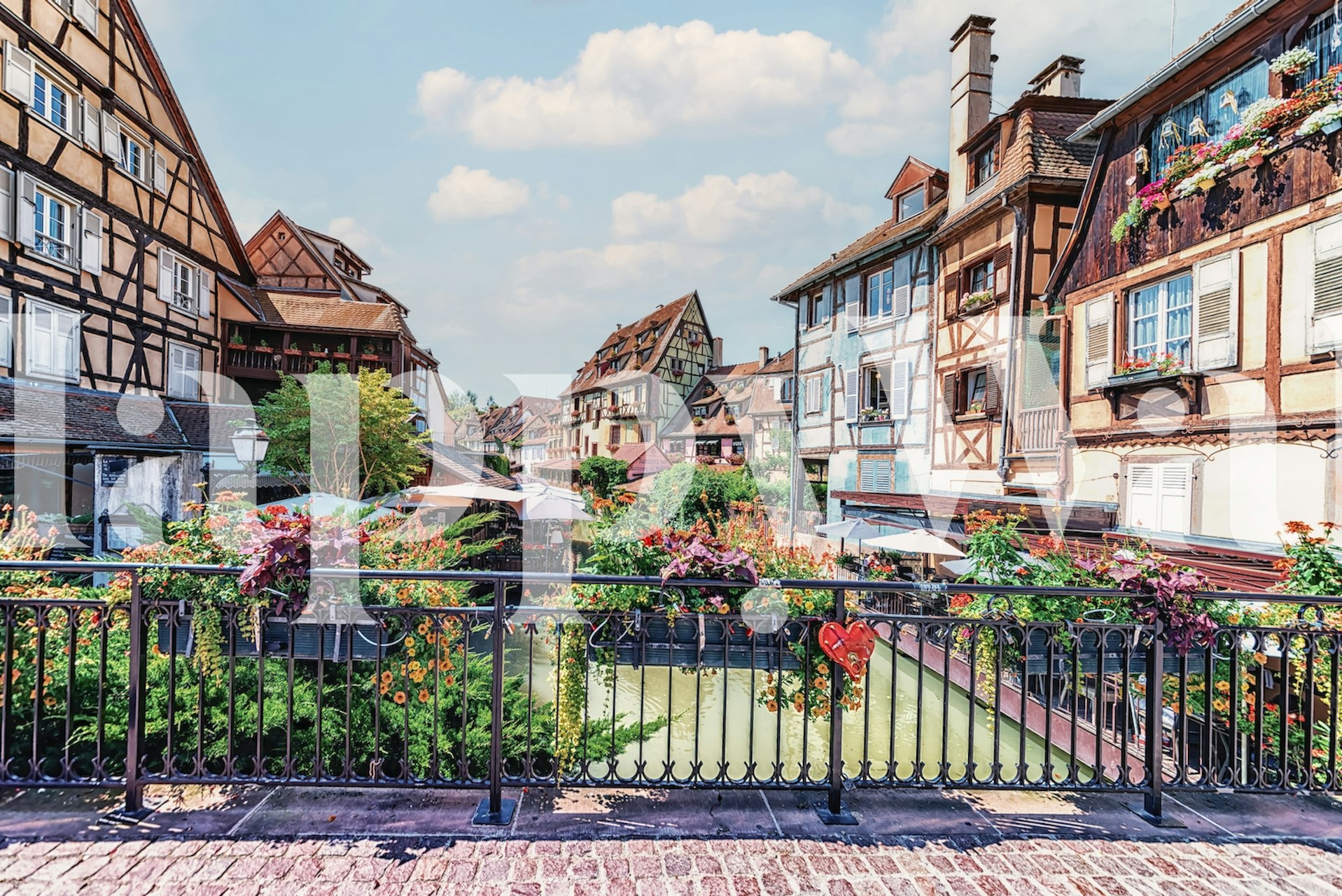 La Petite Venise canal scene with half-timbered houses and flowers