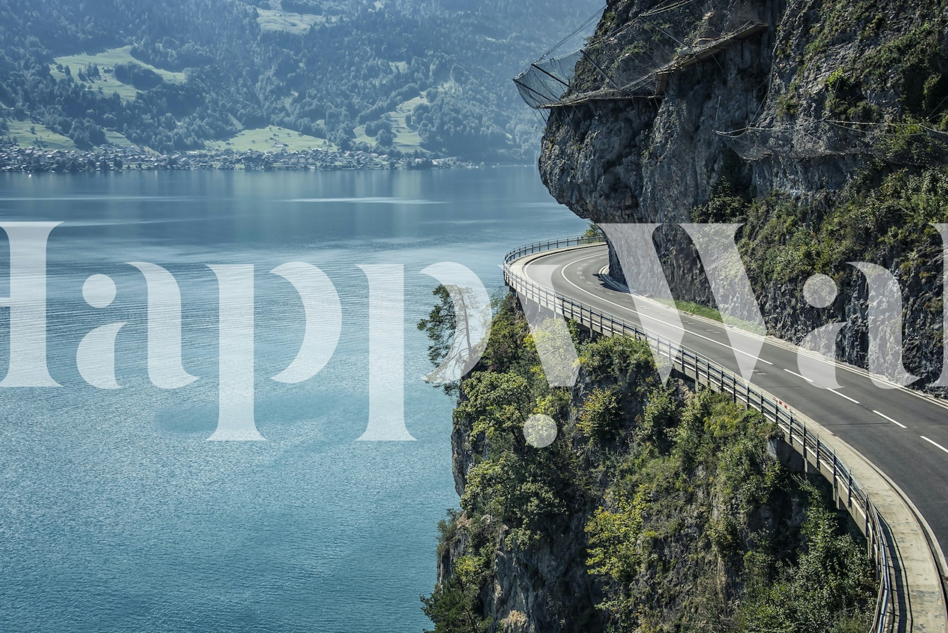 Scenic mountain road wallpaper with blue lake and green hills