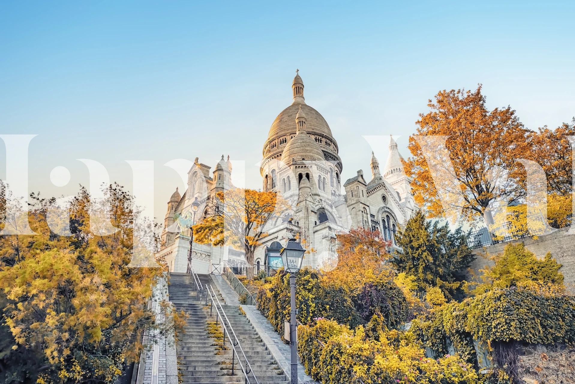 Montmartre autumn scene with golden trees and a cathedral wall mural