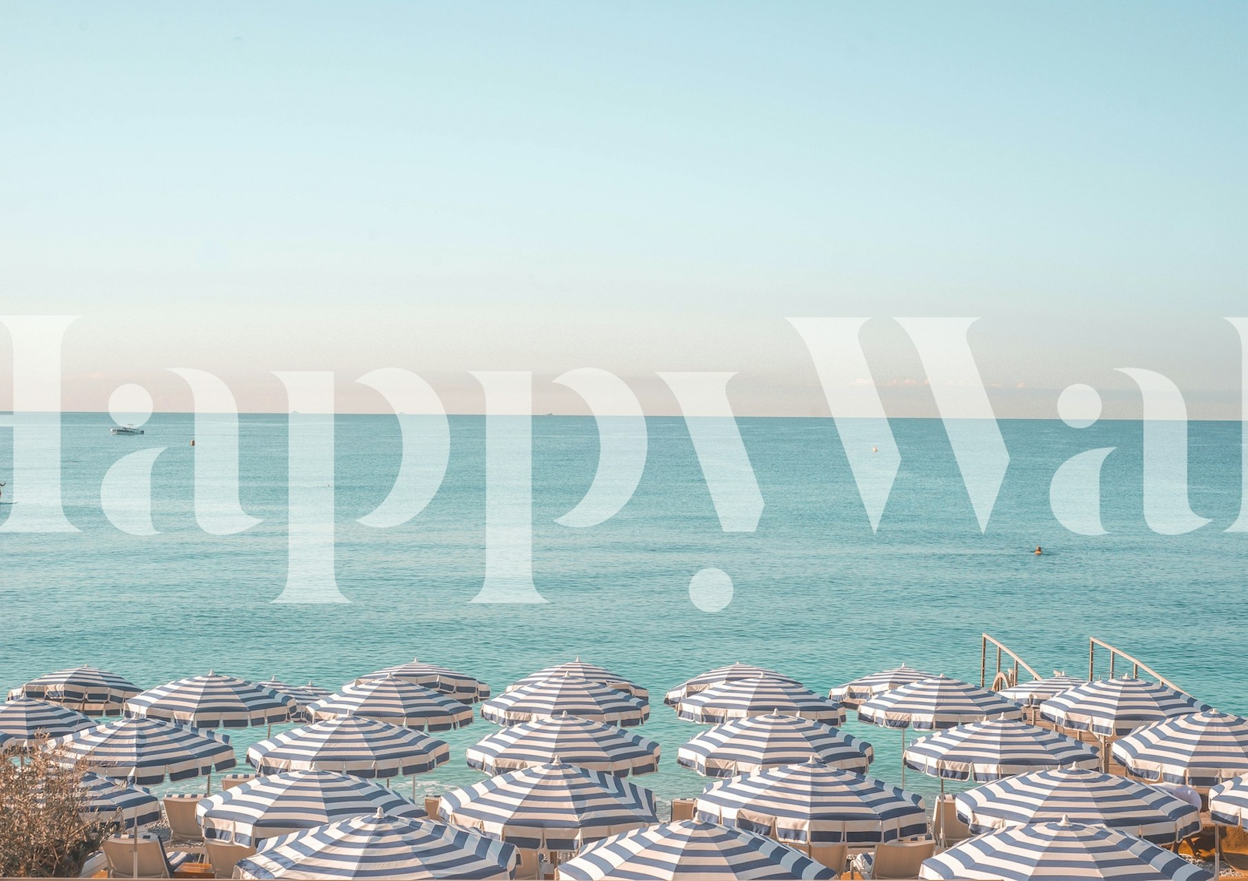 Striped beach umbrellas lined up on the Riviera shore wall mural