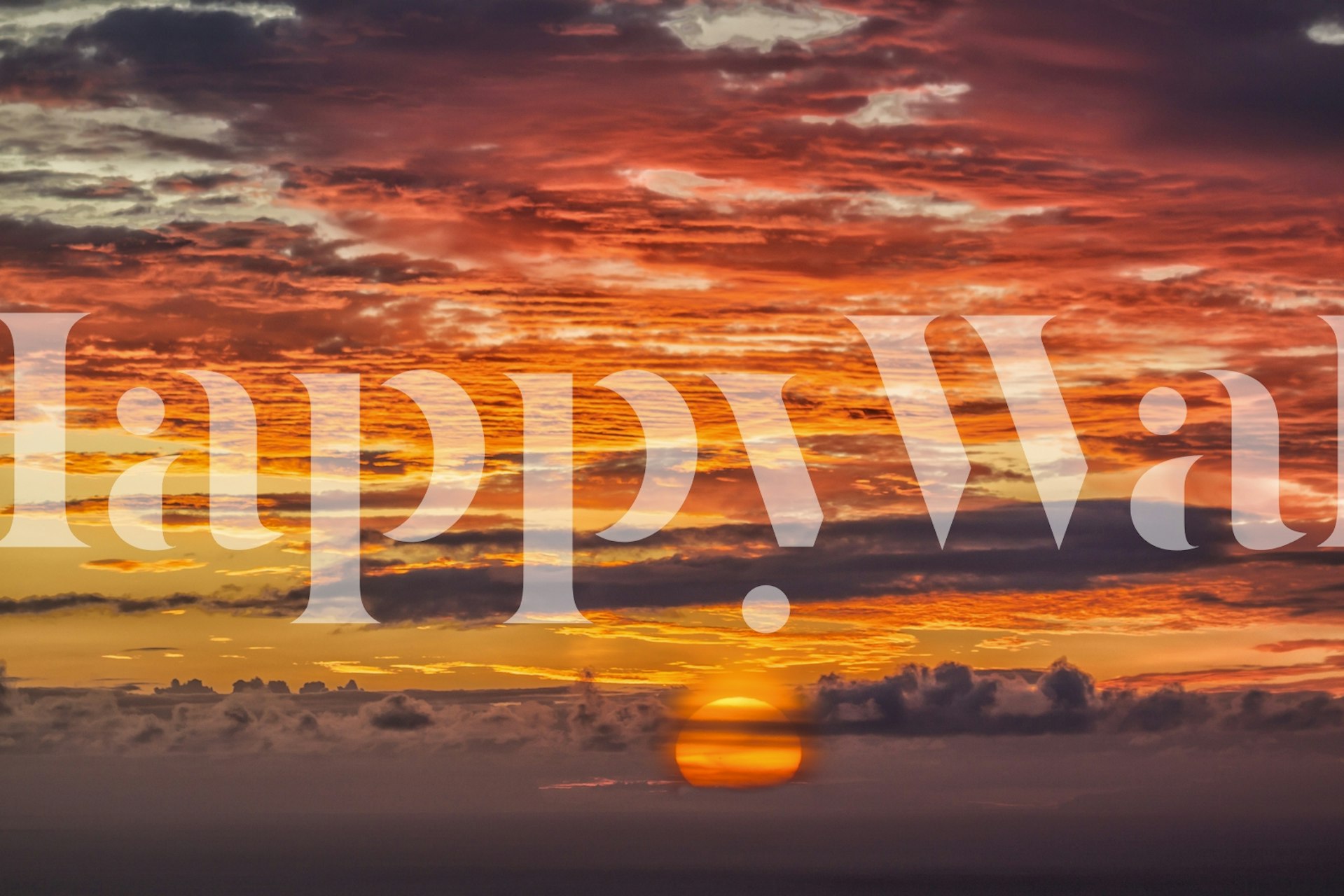 Sunset over ocean with vibrant orange and yellow clouds wallpaper