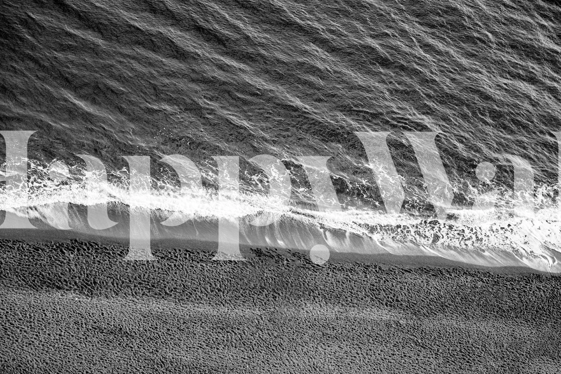 Aerial view of black and white waves and sandy beach wallpaper