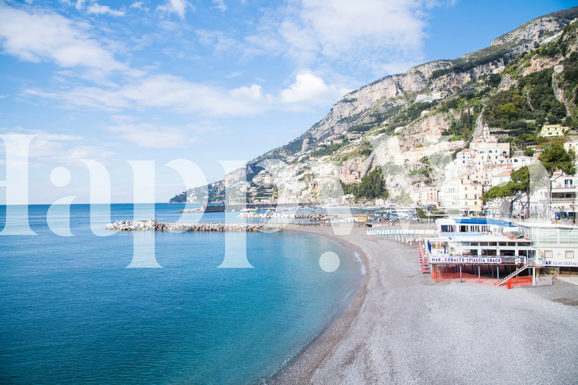 Mediterranean beach scene with green hills and blue water wallpaper