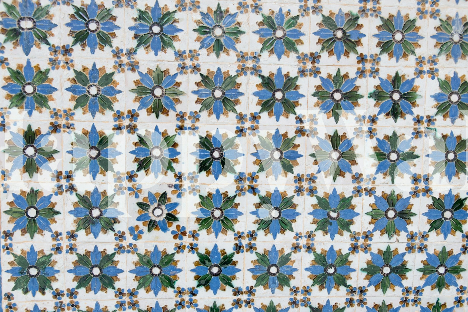 Spanish tiles wallpaper design with blue floral patterns and green leaves in a repeating layout
