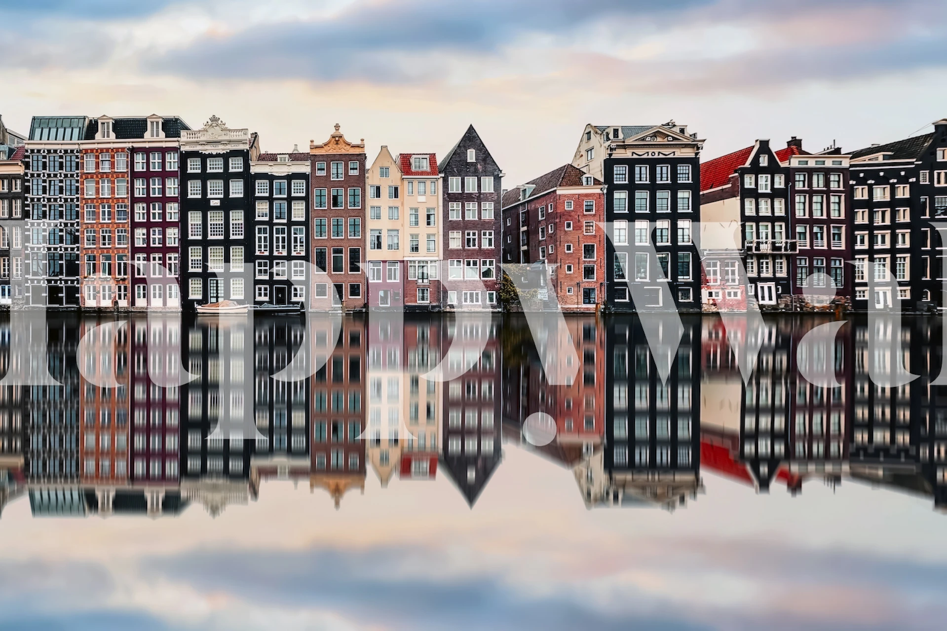 Colorful Amsterdam canal houses reflecting in water wallpaper