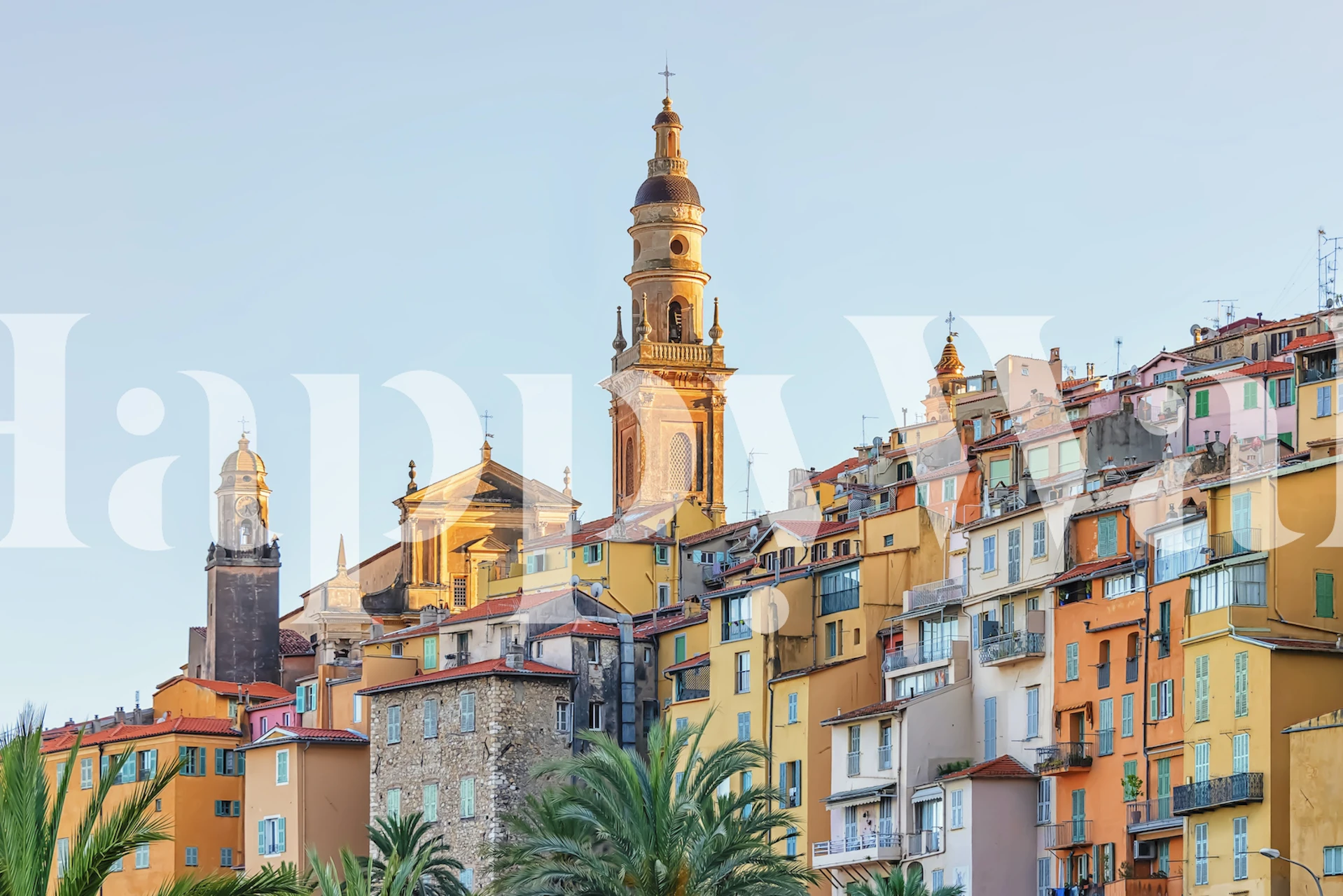 Mediterranean town scene with colorful houses and palm trees wallpaper