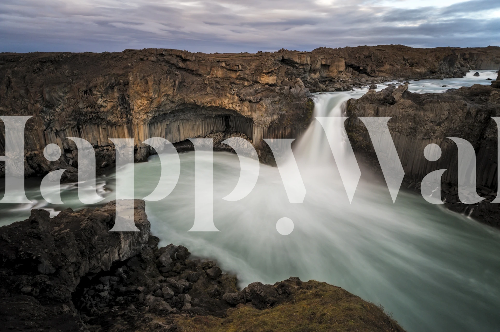 Icelandic waterfall landscape with flowing water and rocky cliffs wallpaper
