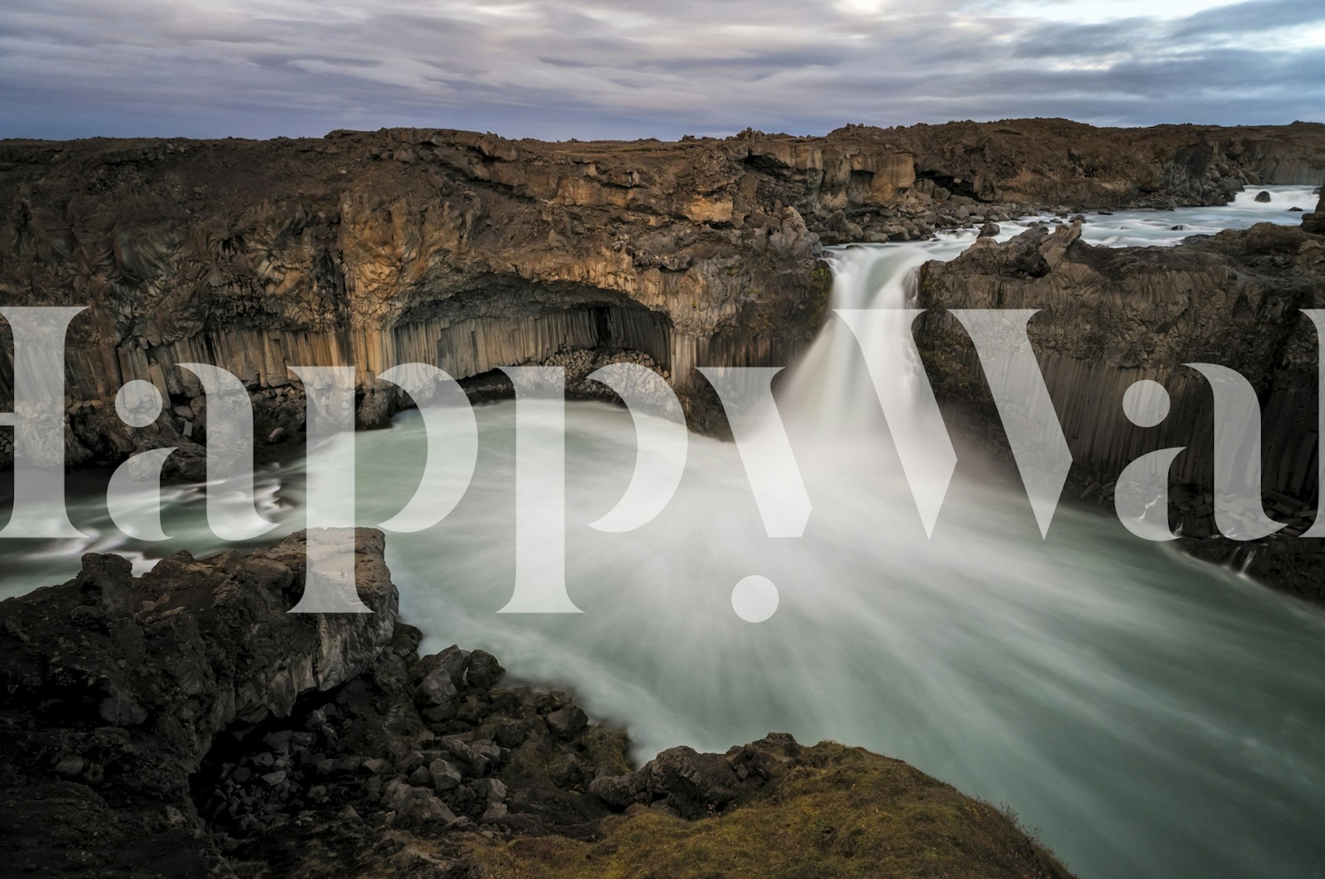 Icelandic waterfall landscape with flowing water and rocky cliffs wallpaper