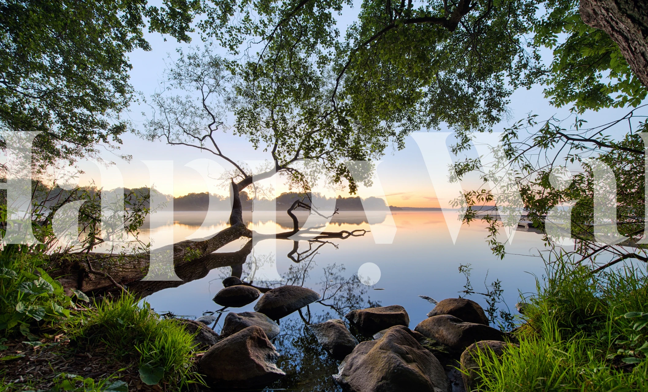 Lake view with trees and rocks reflecting on water wallpaper