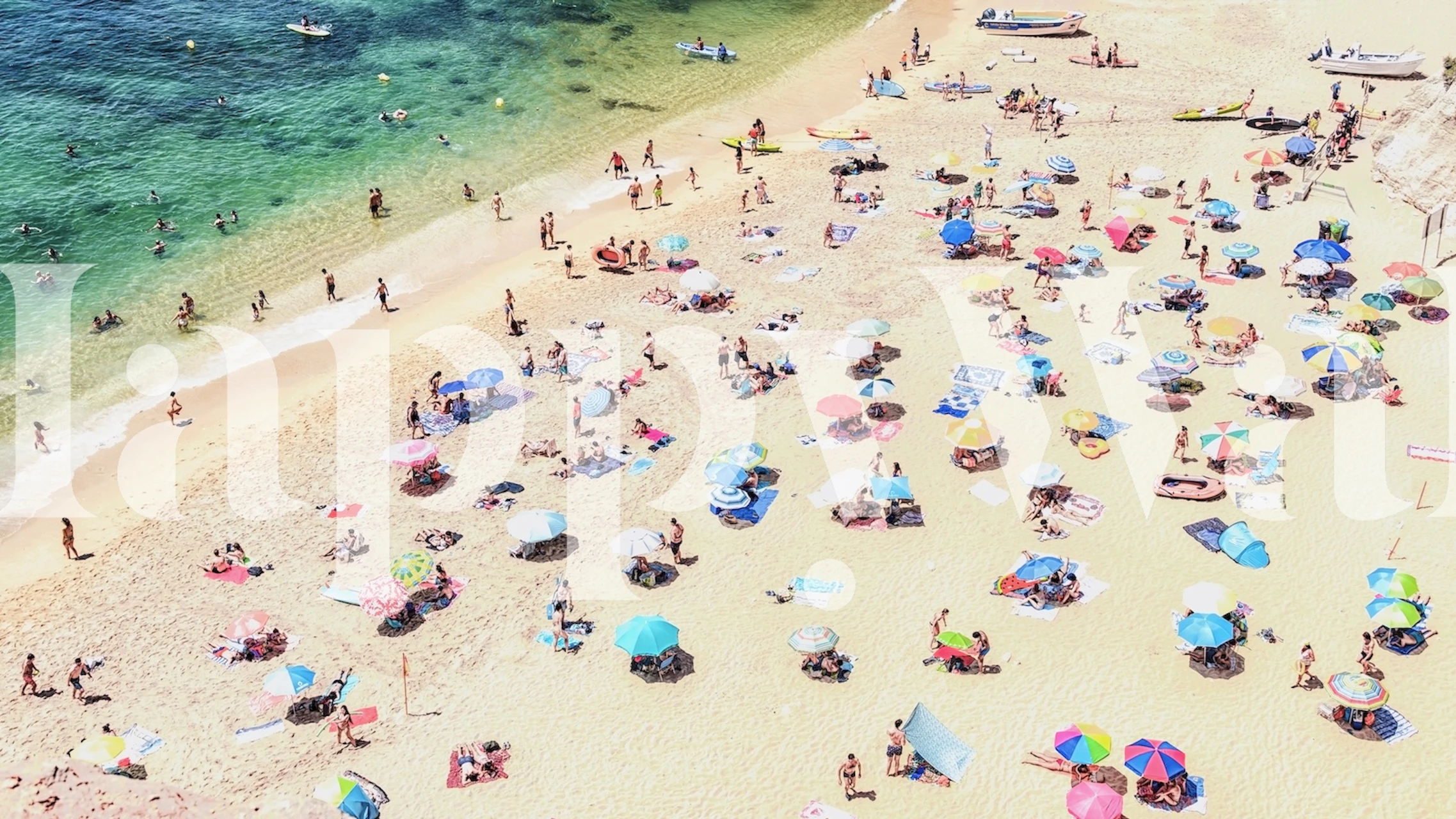 Aerial view of Benagil beach wall mural with sunbathers and colorful umbrellas