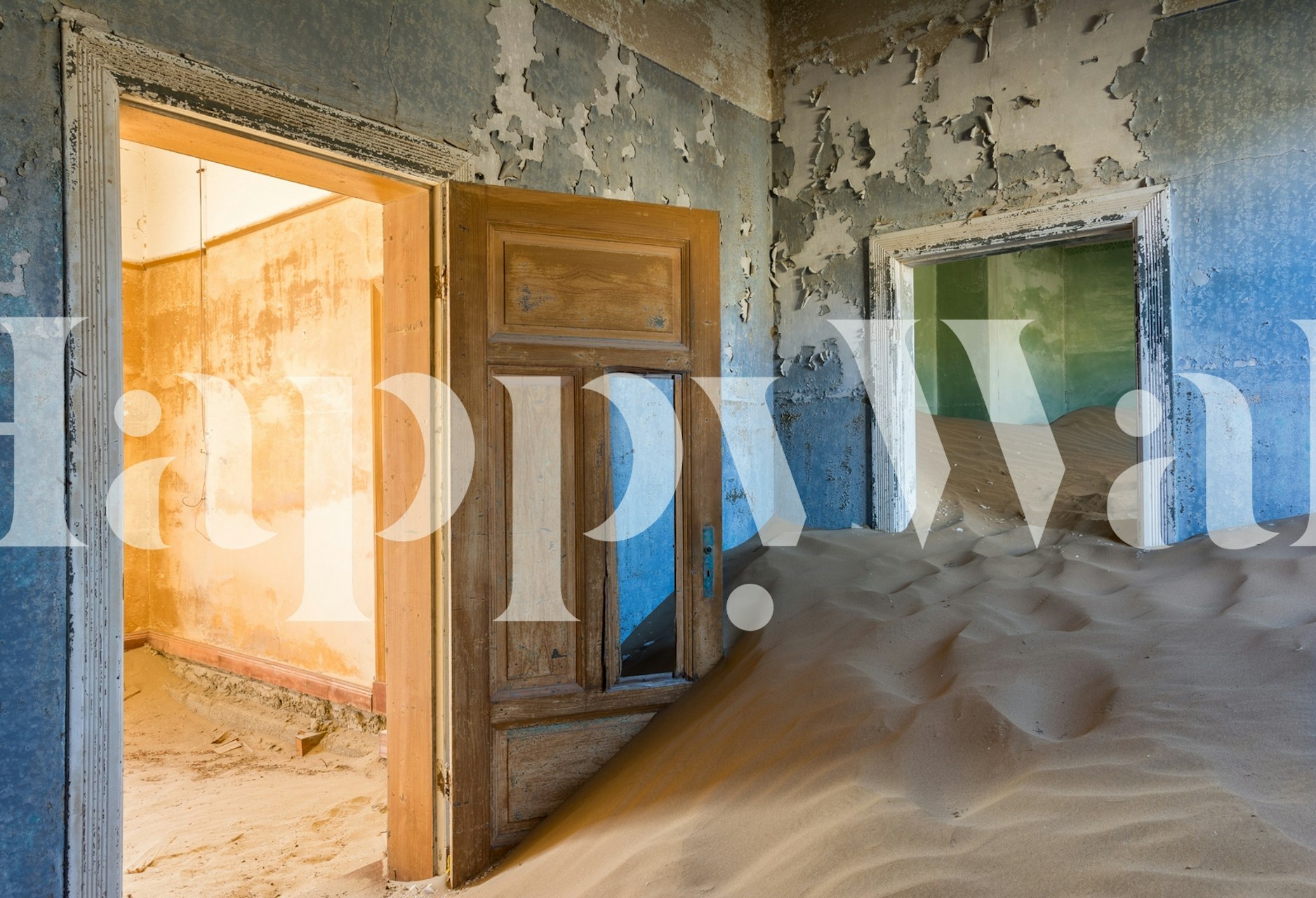Abandoned room with sand on the floor and sunlight shining through doorways wall mural