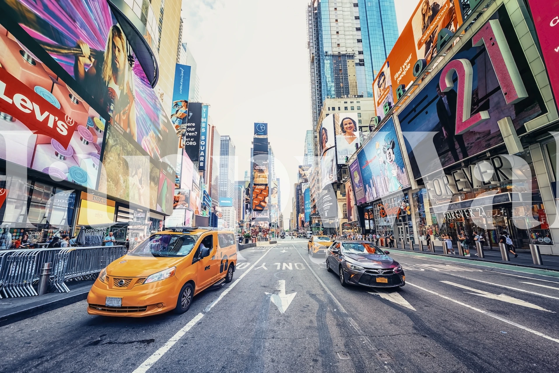 Times Square wall mural showing busy city life with taxis and billboards.