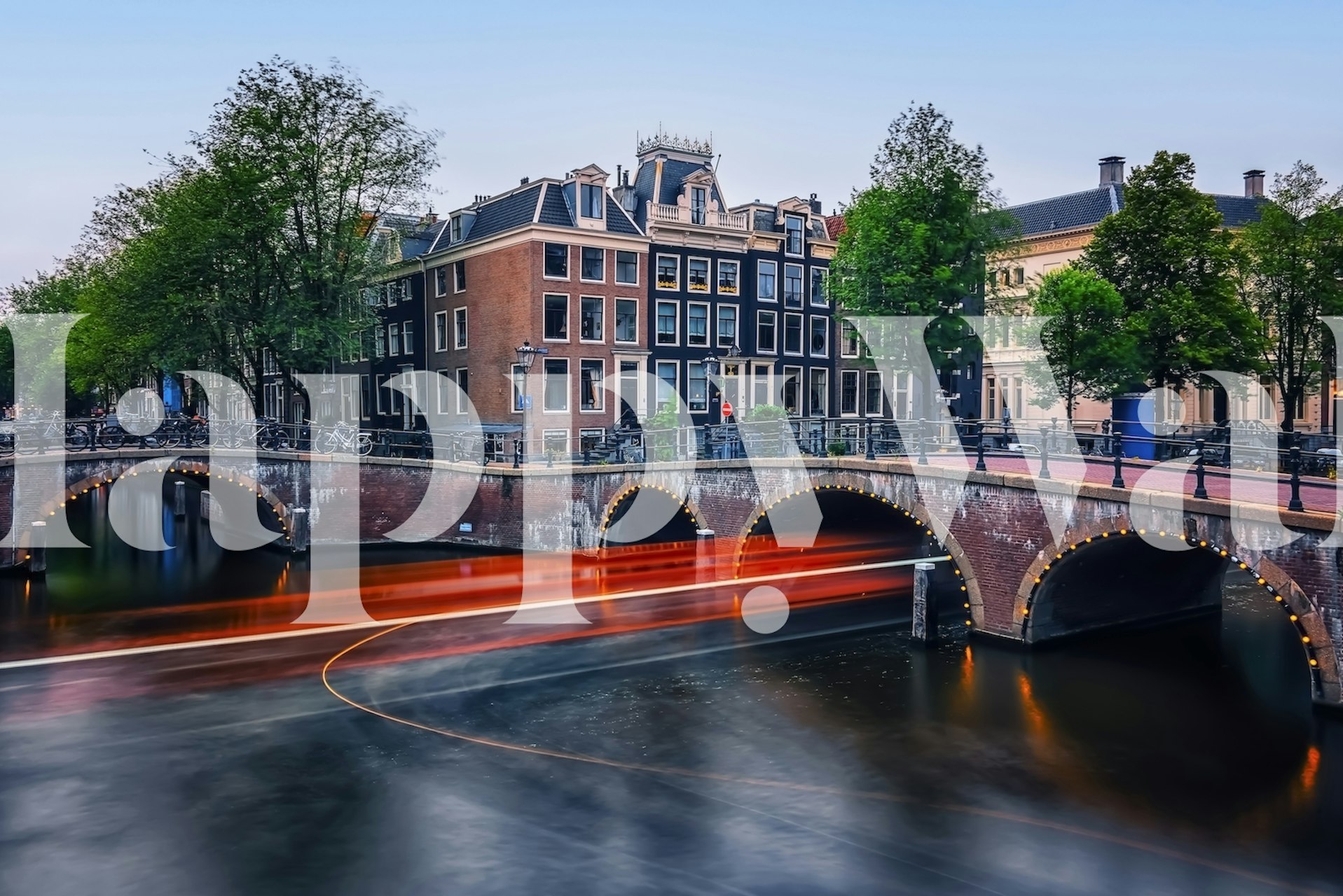 Amsterdam bridge over a canal with colorful buildings and trees wallpaper
