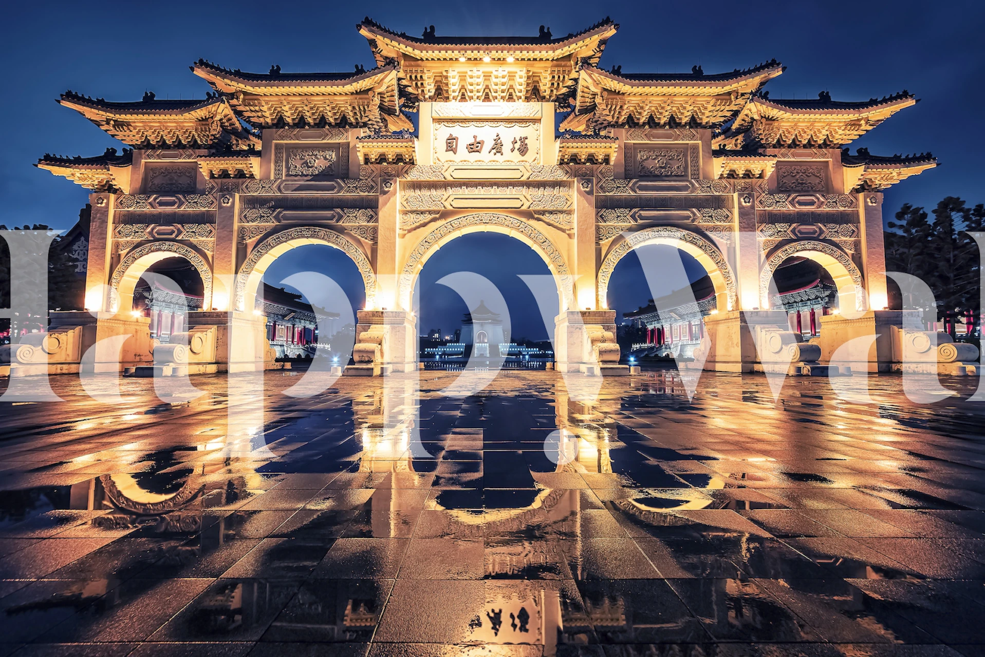 Golden archway illuminated at night with reflections on the ground wallpaper