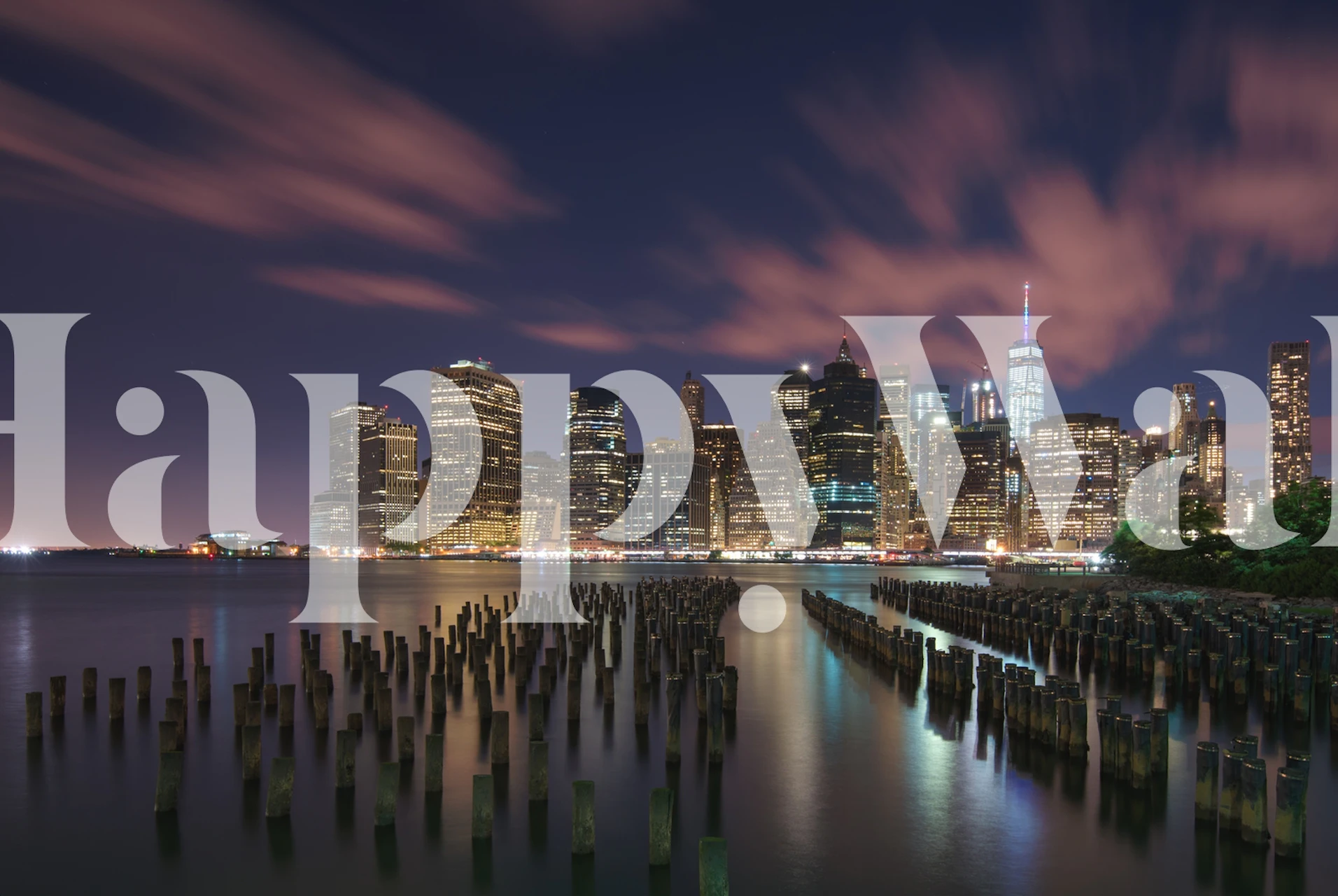 New York City skyline with bright lights reflecting in water at night