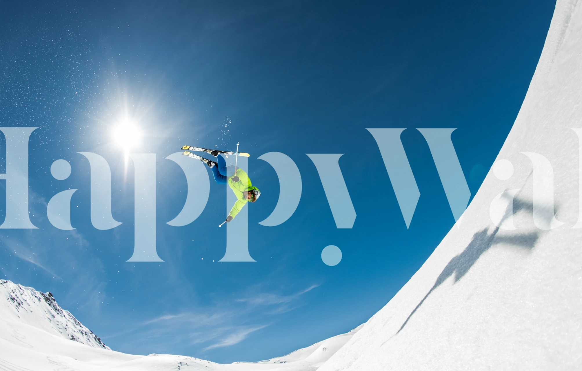 Skiing action against a bright blue sky wallpaper