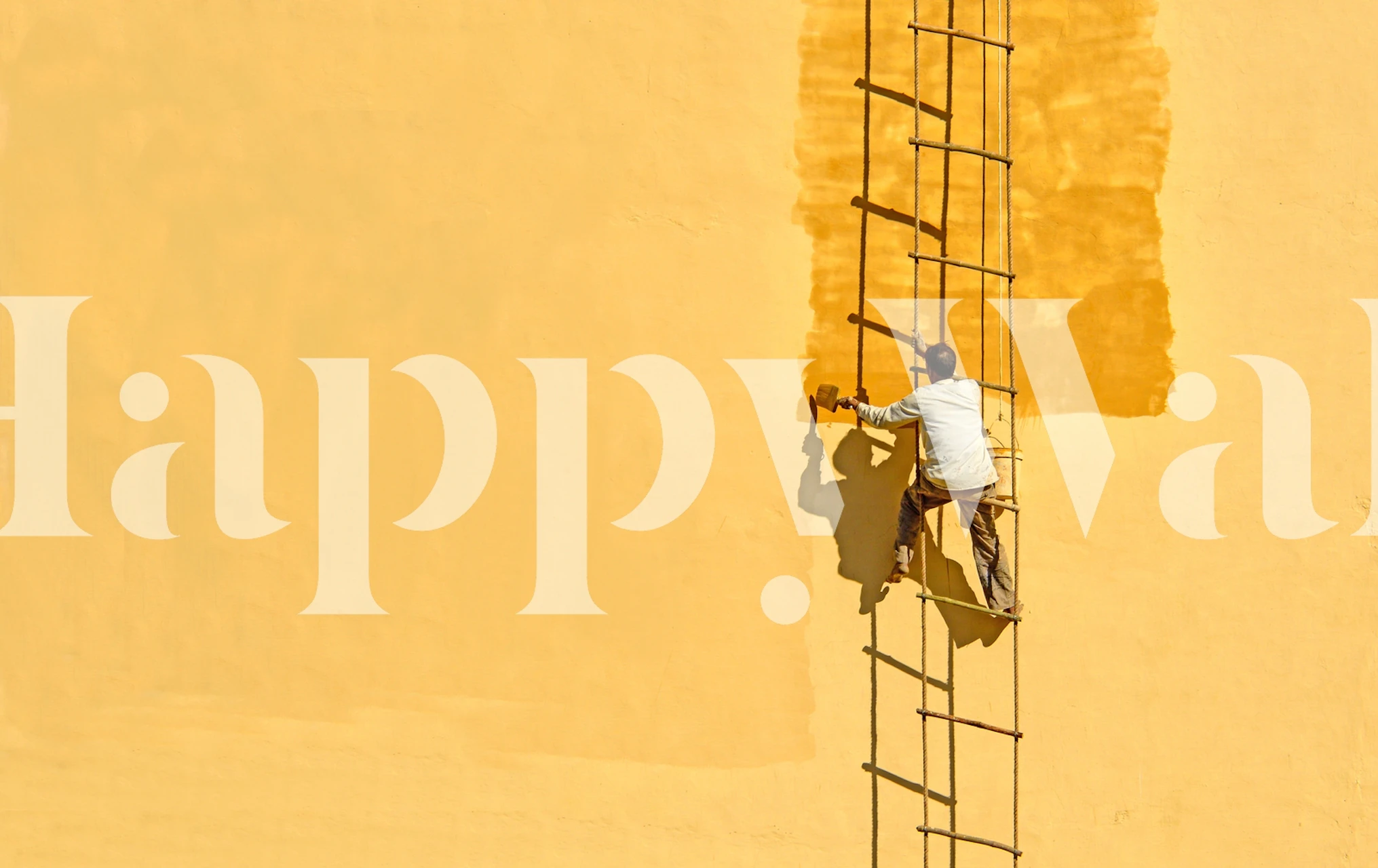 Man on ladder painting a yellow wall modern wallpaper