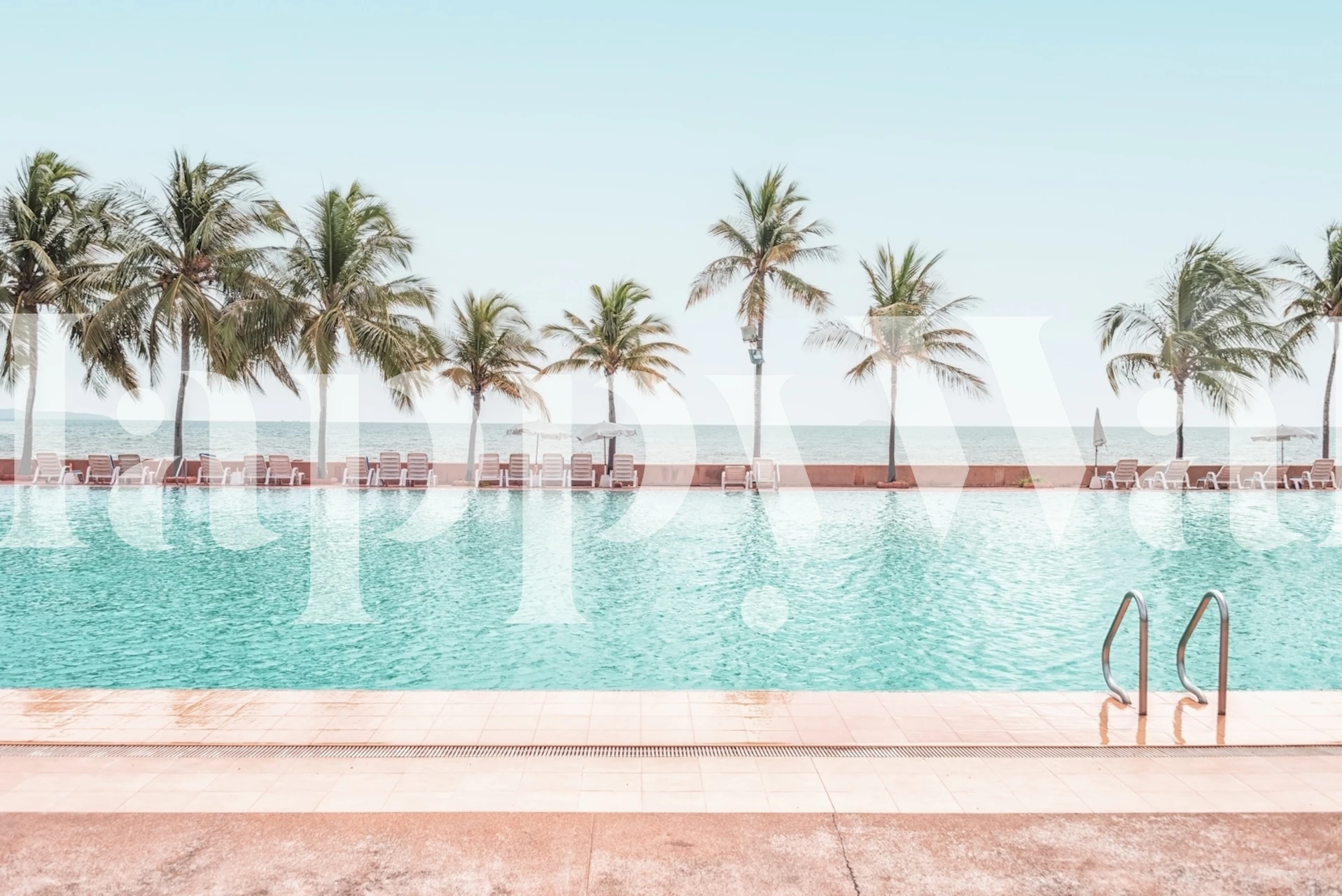 Tropical pool and beach scene wallpaper with blue hues and palm trees