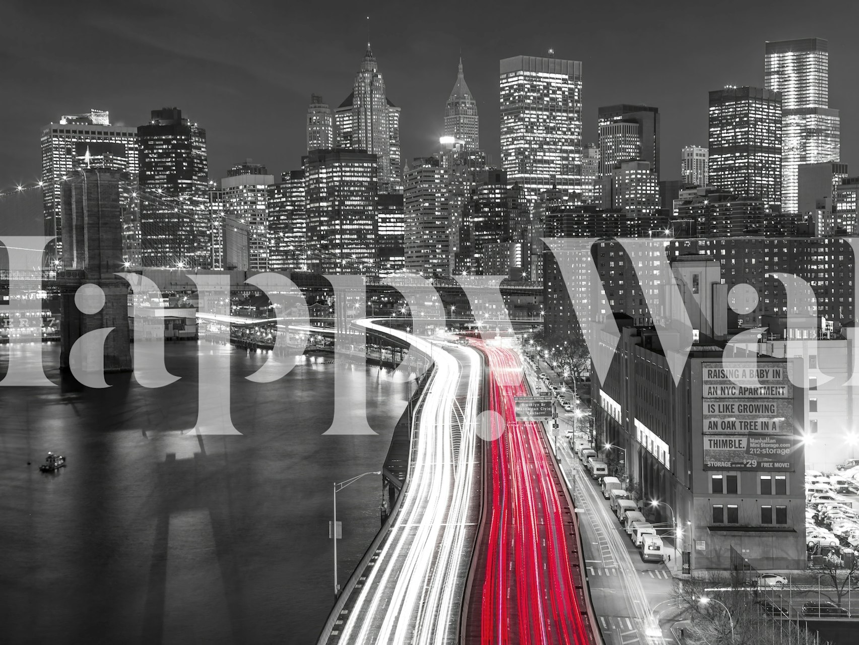 A black and white cityscape wall mural with a vibrant red light strip from trailing traffic lights.
