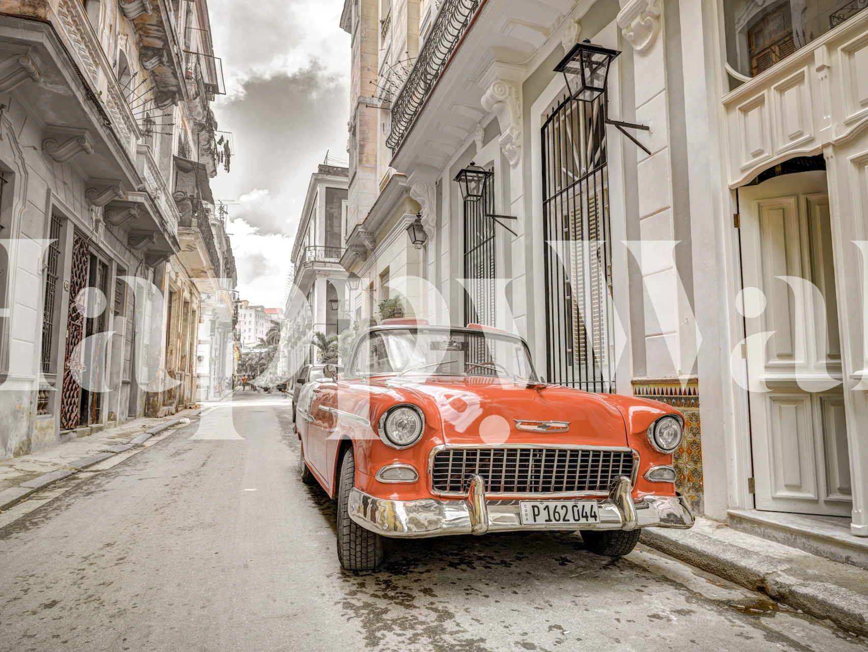 Vintage car parked on a cobbled street with historic buildings wallpaper