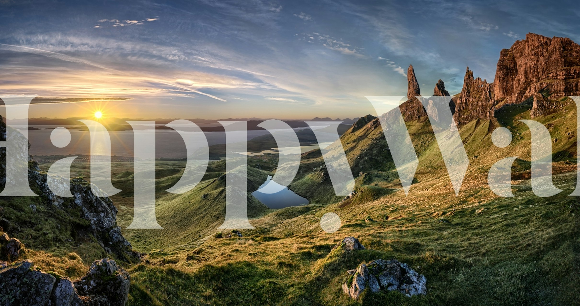 Storr Mountain landscape wallpaper featuring green hills, blue lake, and sunset colors.