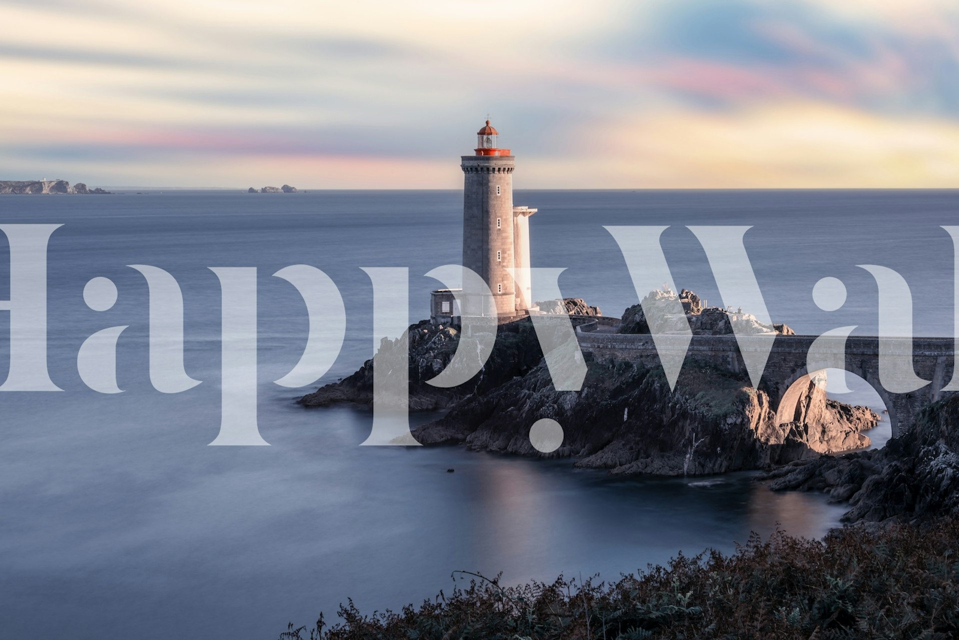Coastal lighthouse on rocky cliff with blue sky wallpaper