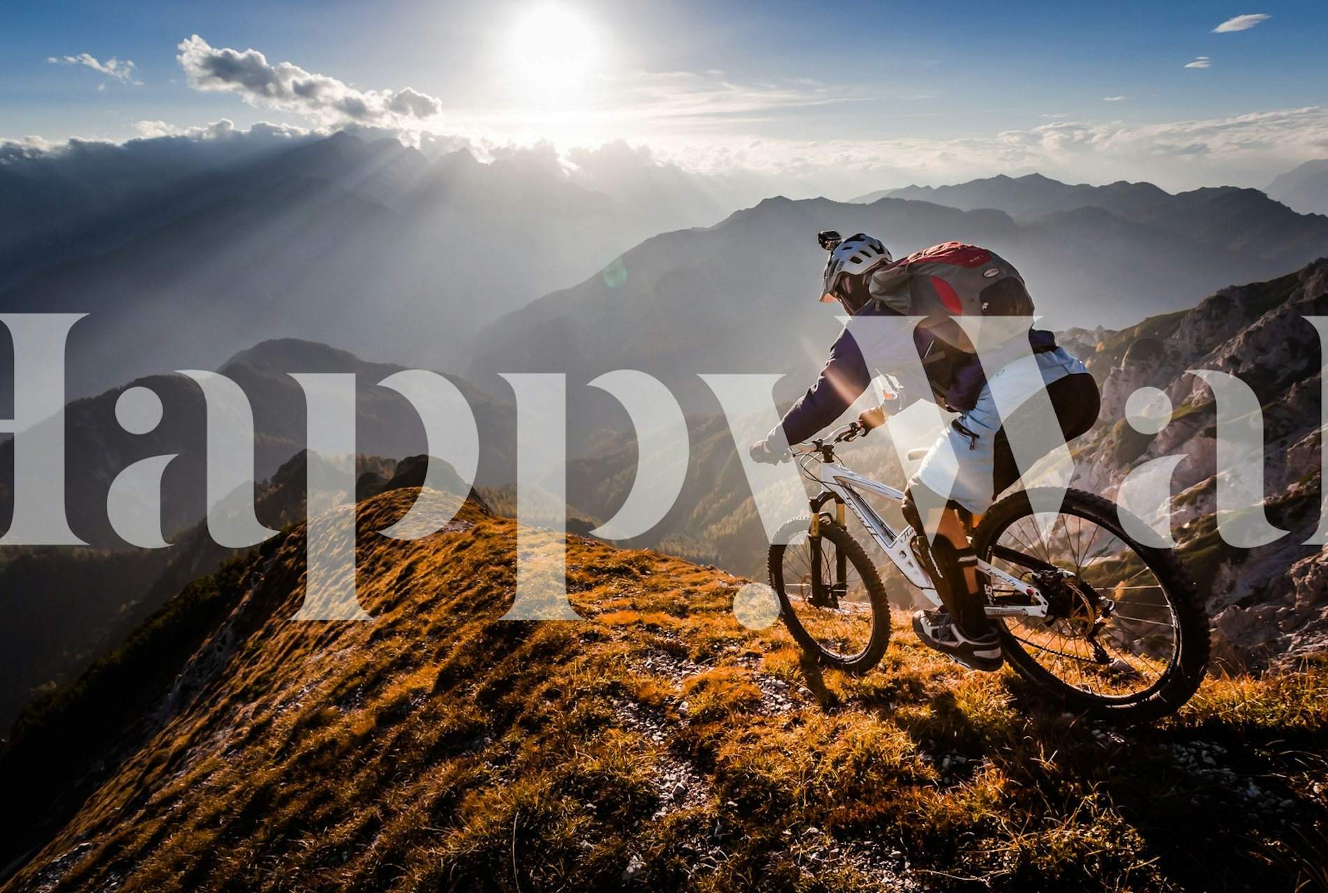 Mountain biking adventure wall mural with sunset and rugged terrain
