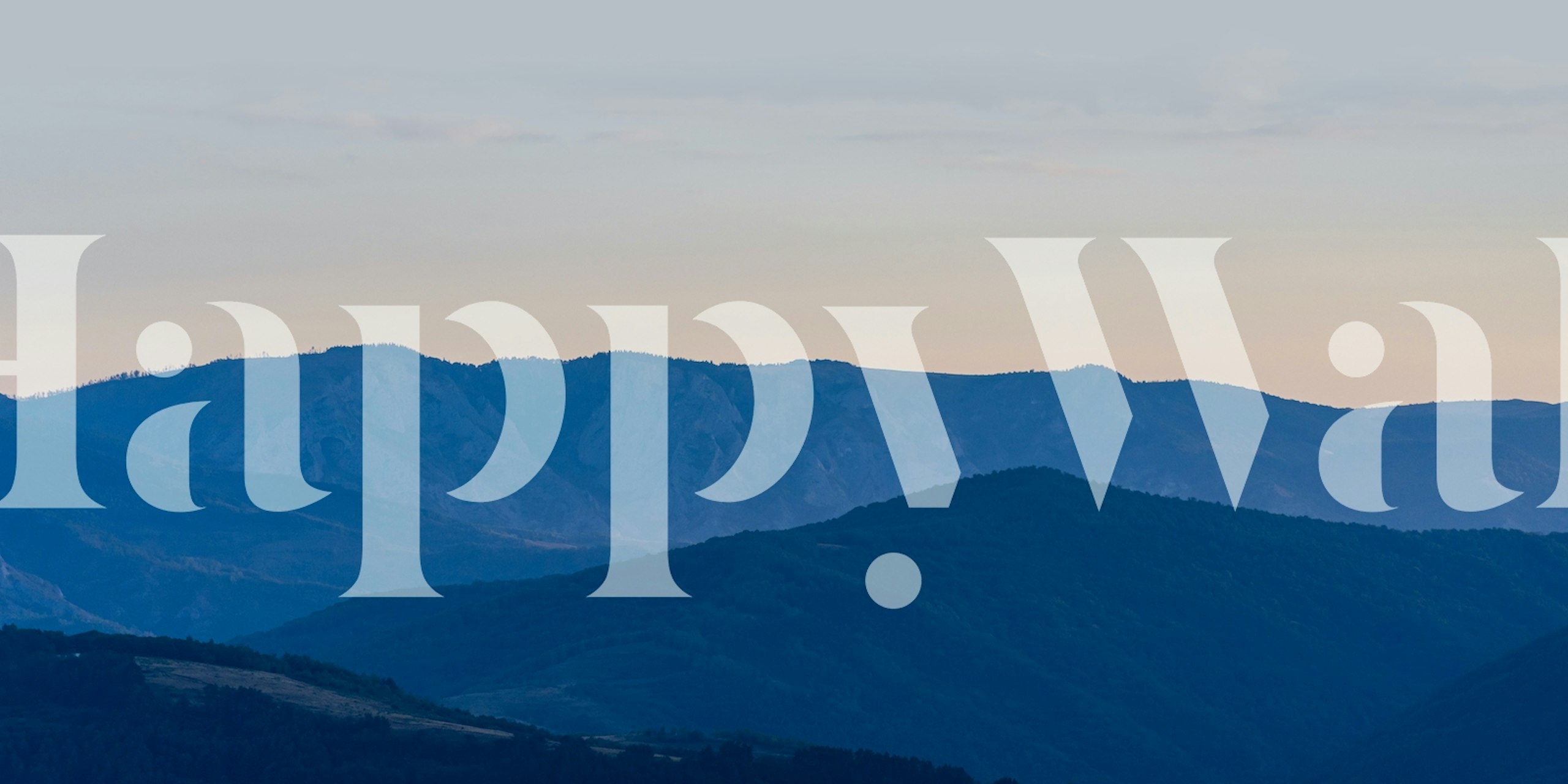 Layered blue mountain range silhouette wallpaper