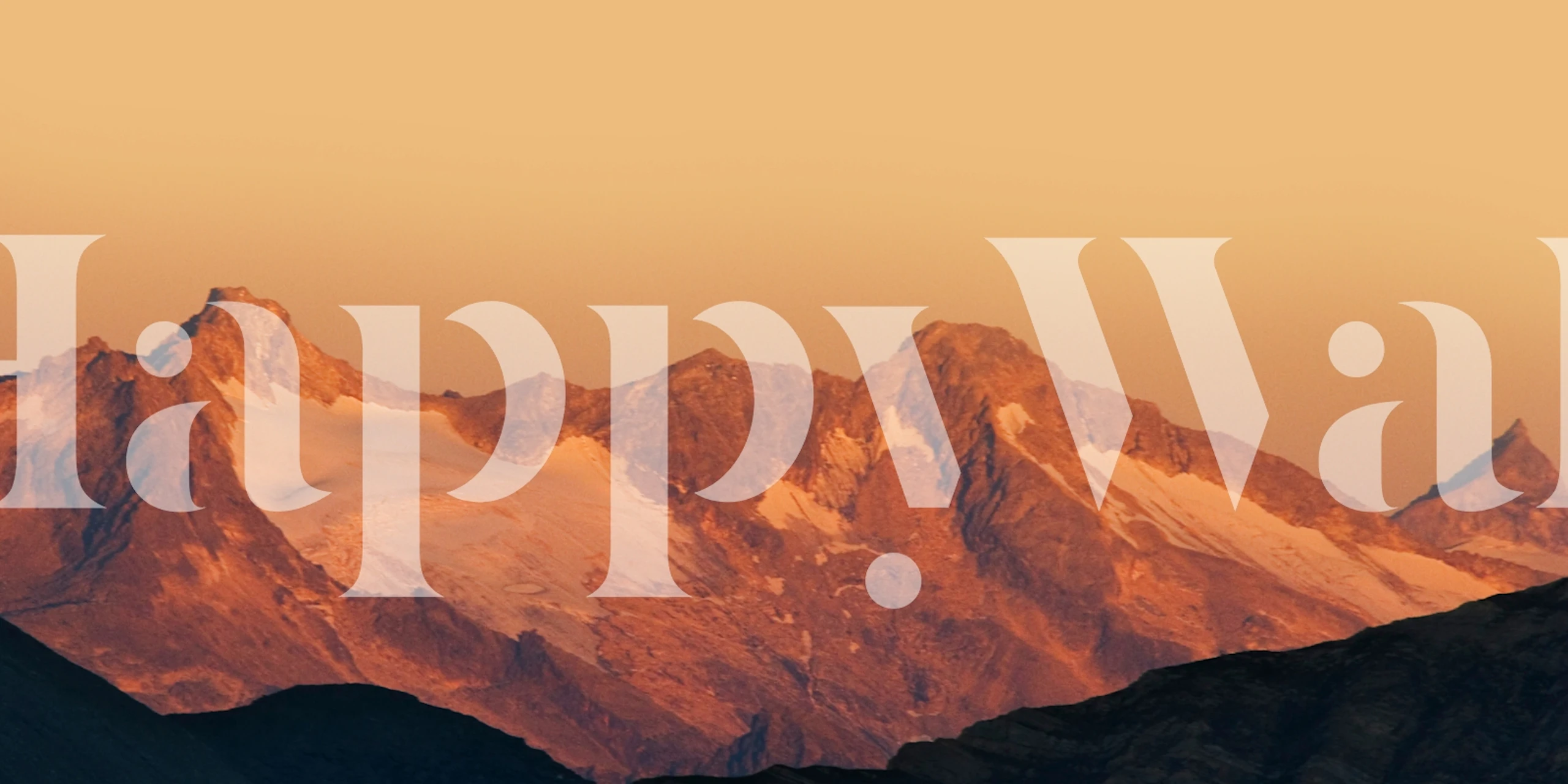 Mountain landscape at sunset with warm orange and brown tones wallpaper