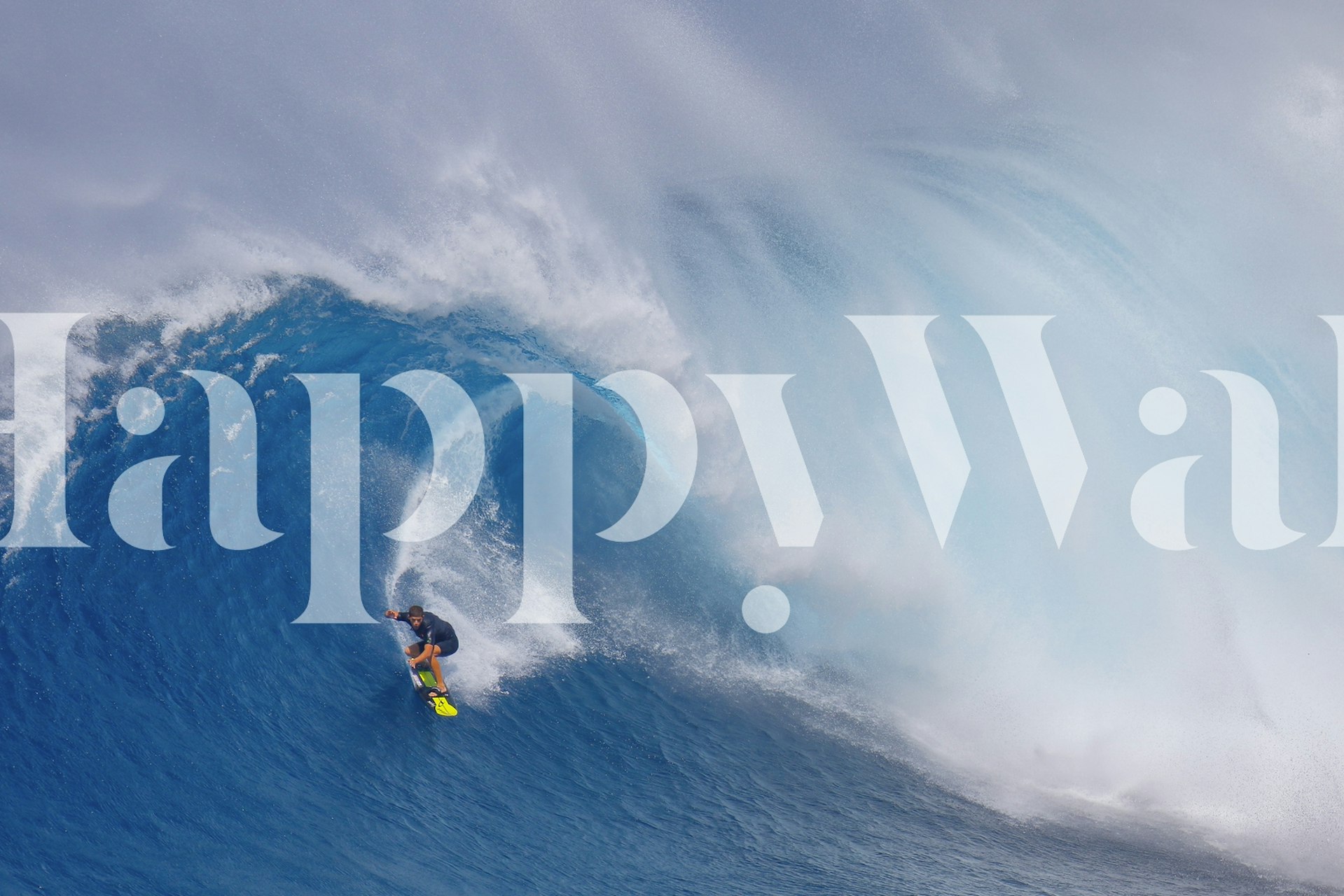 Surfer riding a massive wave in vibrant blue colors wallpaper