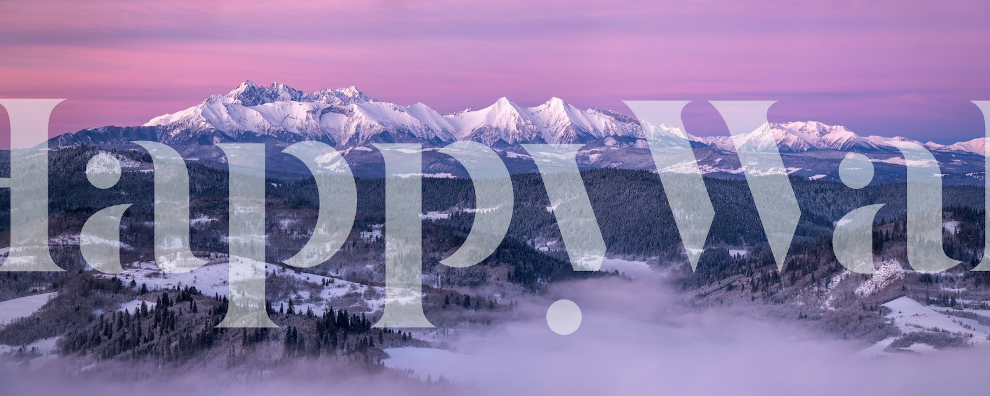 Dawn breaking over the snow-capped Tatra Mountains with a pink and purple sky