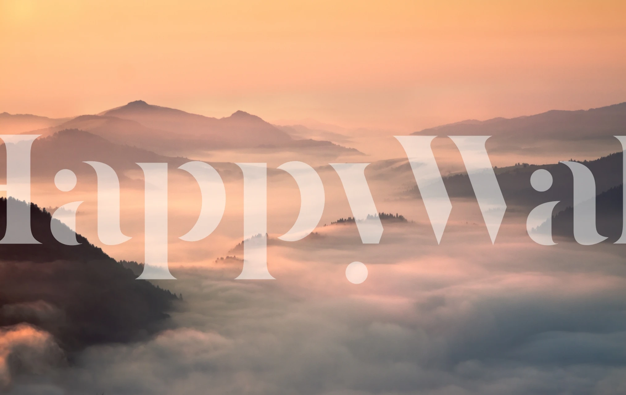 Foggy mountain landscape with soft pink and purple hues wallpaper