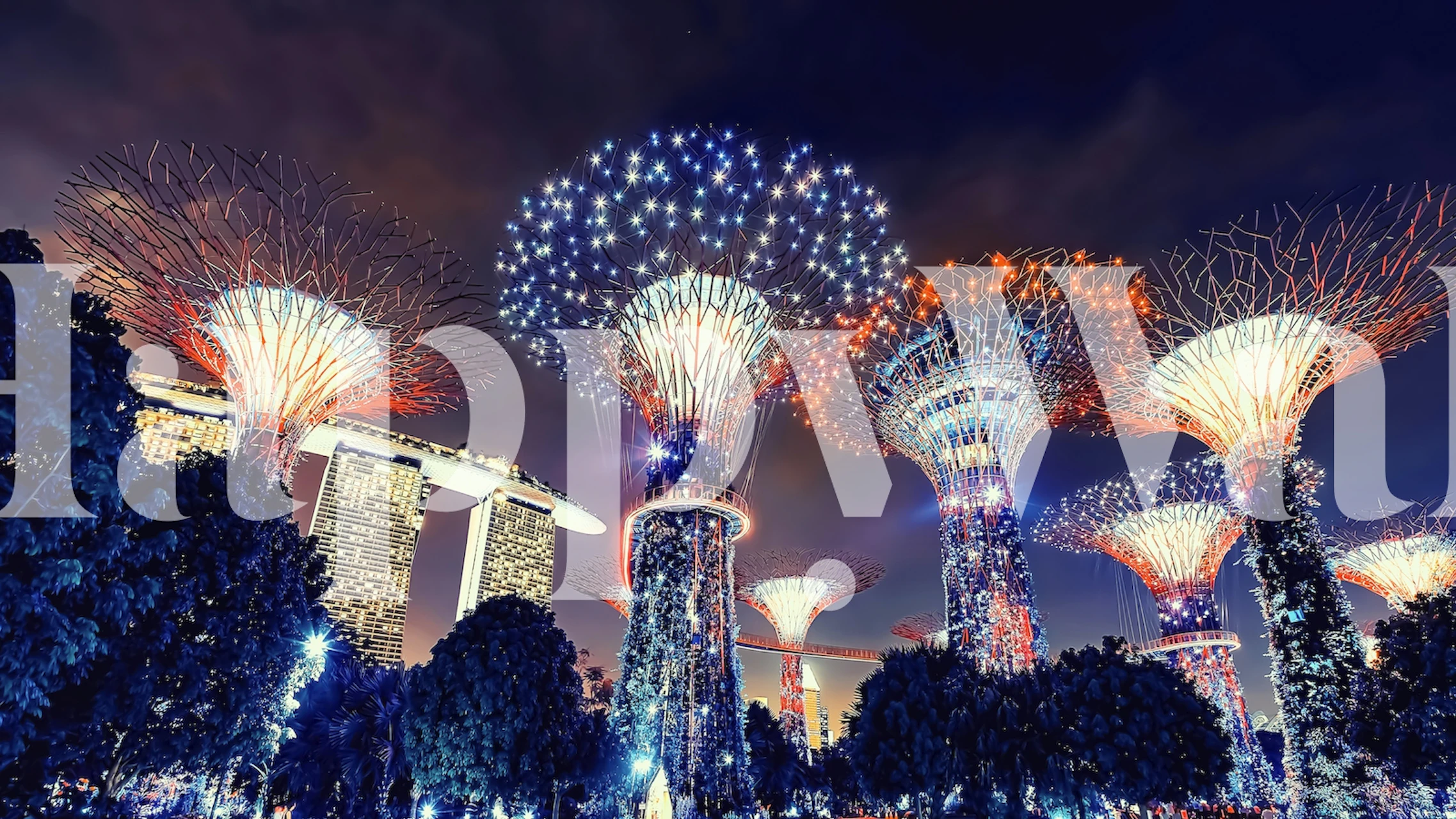 Futuristic tree-like structures in luminous Gardens By The Bay wall mural