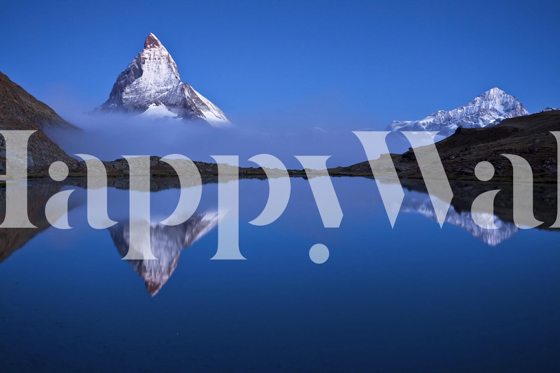 Mountain reflection in blue waters with snowy peaks wallpaper