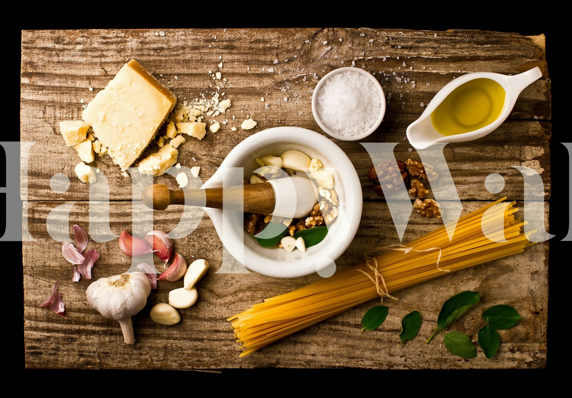 Wall mural with Italian cooking ingredients including basil, cheese, garlic, and olive oil on a wooden background