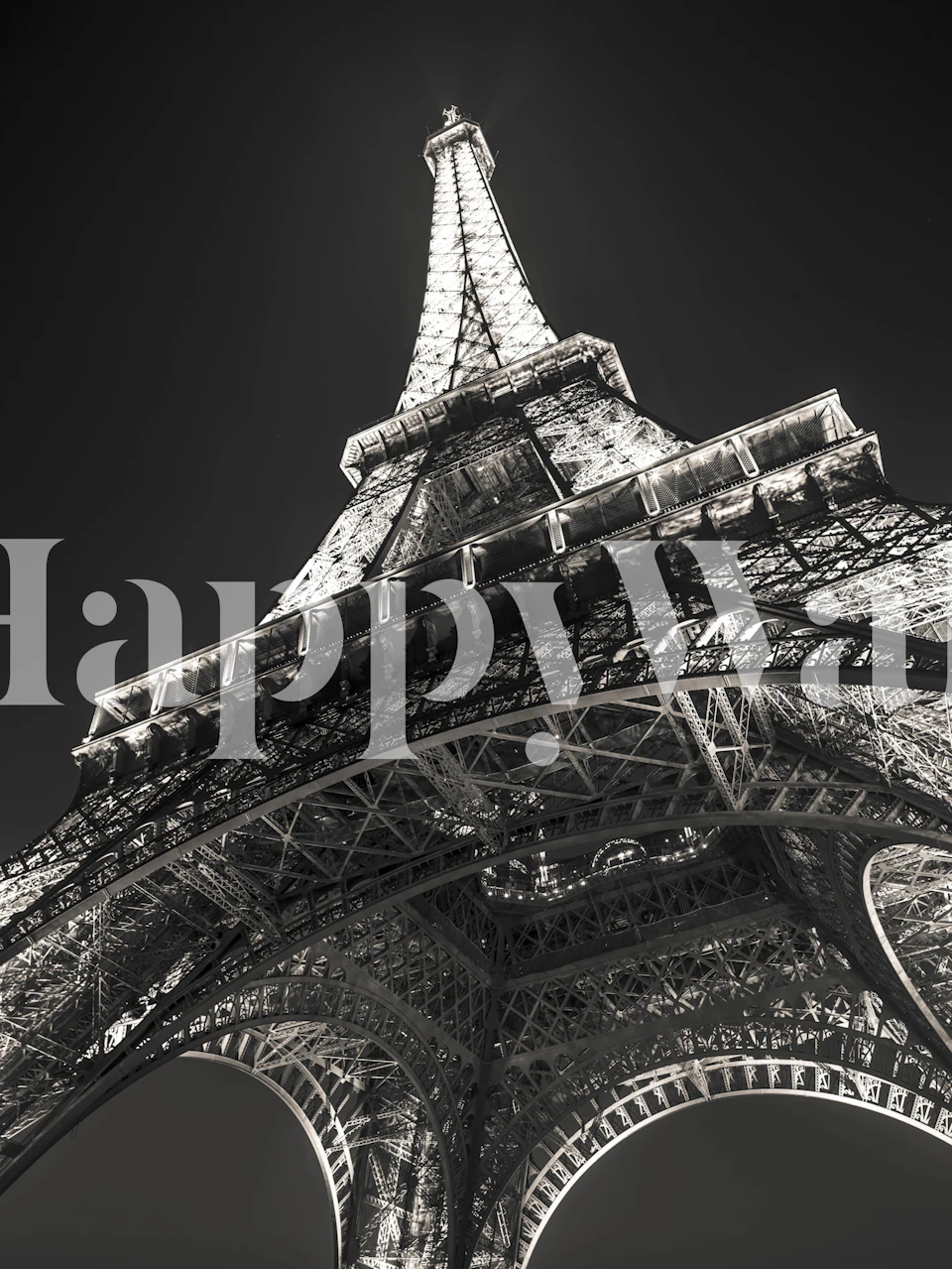 Under the Eiffel Tower wall mural showing the intricate ironwork structure from below