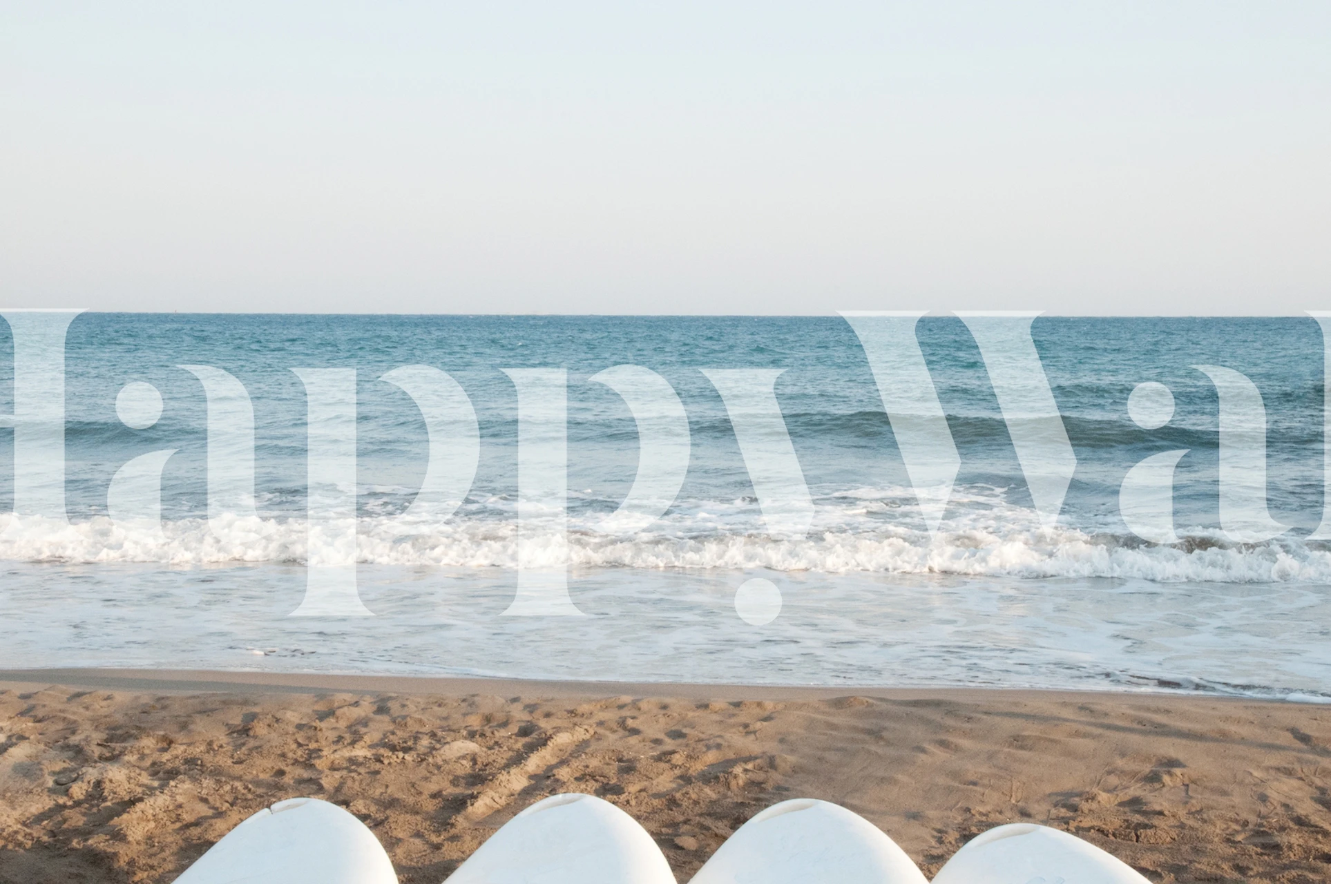 White surfboards on sandy beach with ocean backdrop wallpaper
