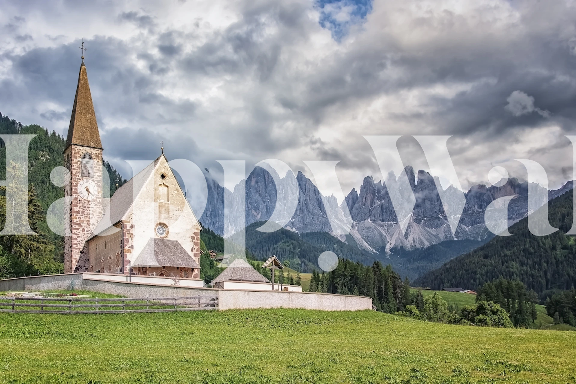 A solitary church under the towering presence of alpine mountains, surrounded by a verdant landscape.