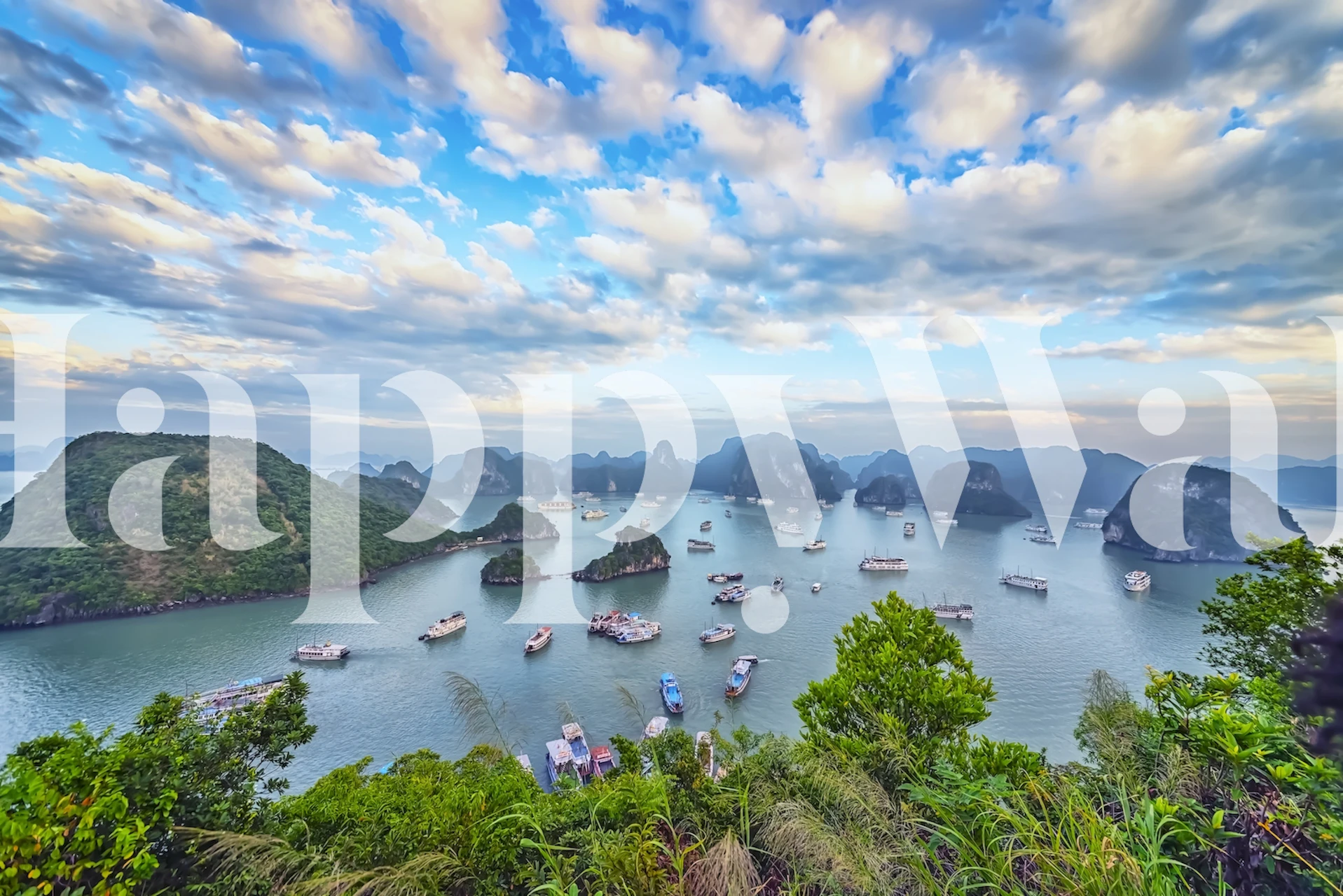 Halong Bay landscape with boats, greenery, and blue sky wallpaper