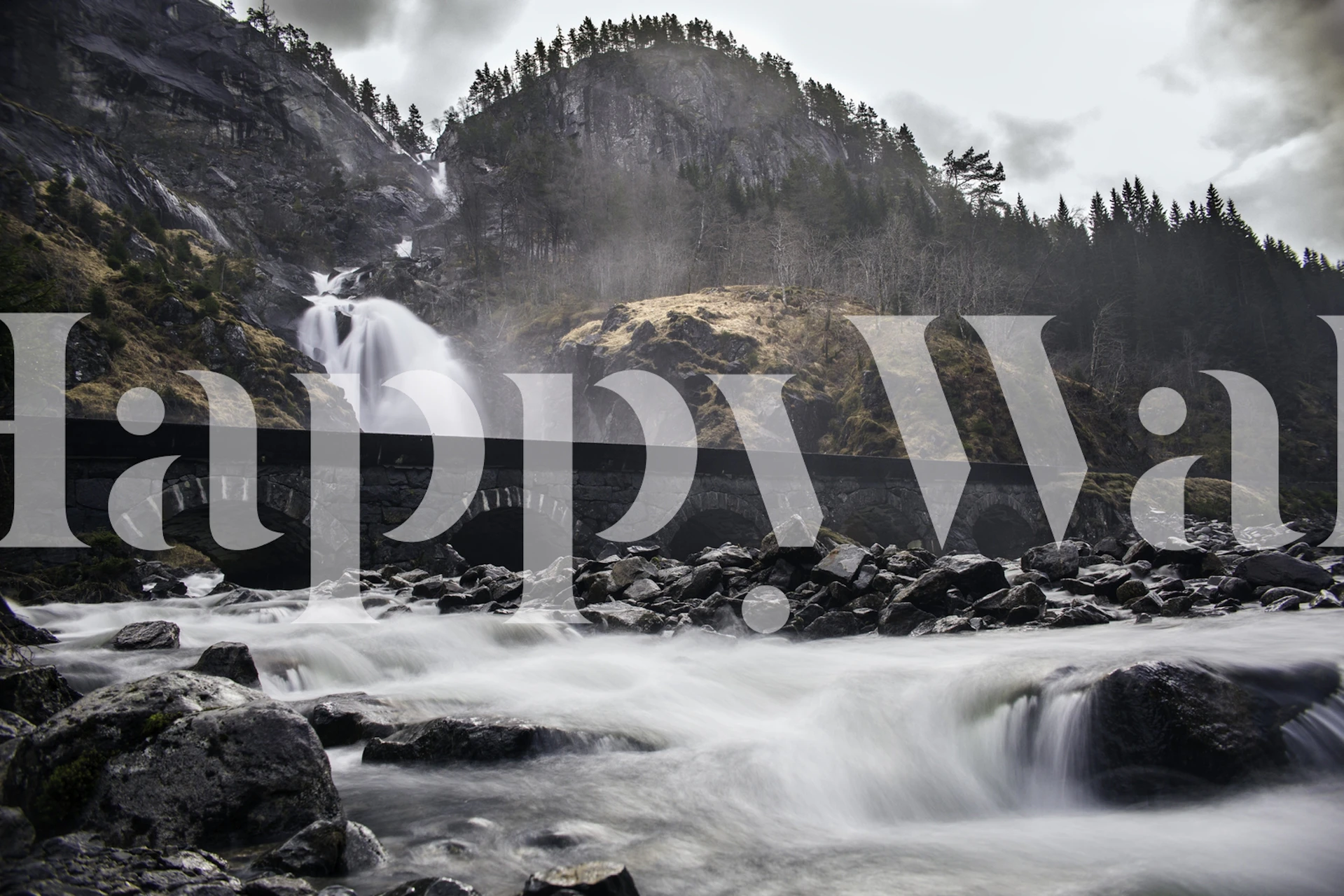 Misty waterfall and craggy peaks wall mural
